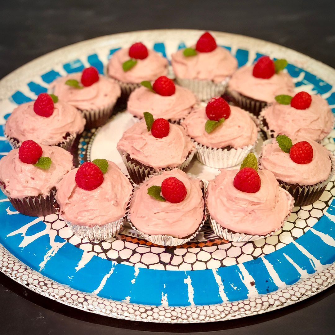 Chocolate cupcakes with raspberry frosting, and mint