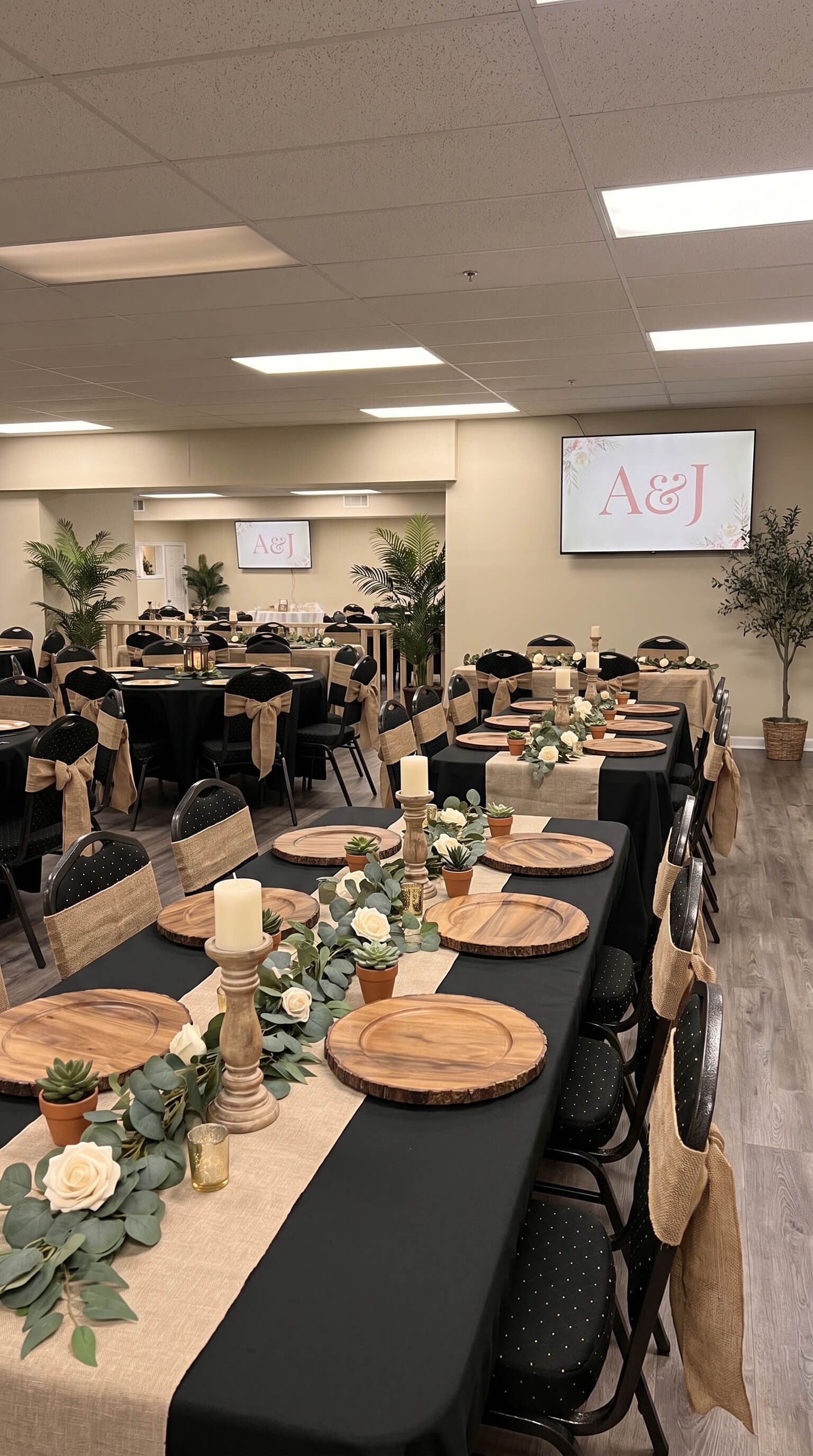 Decorated banquet hall with long dining tables set for an event