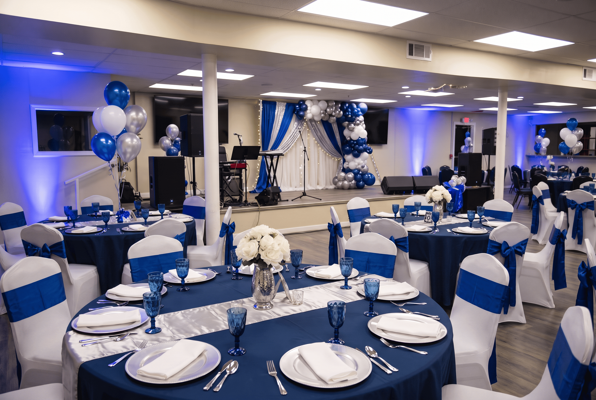 Blue and white decorated banquet hall with round tables set