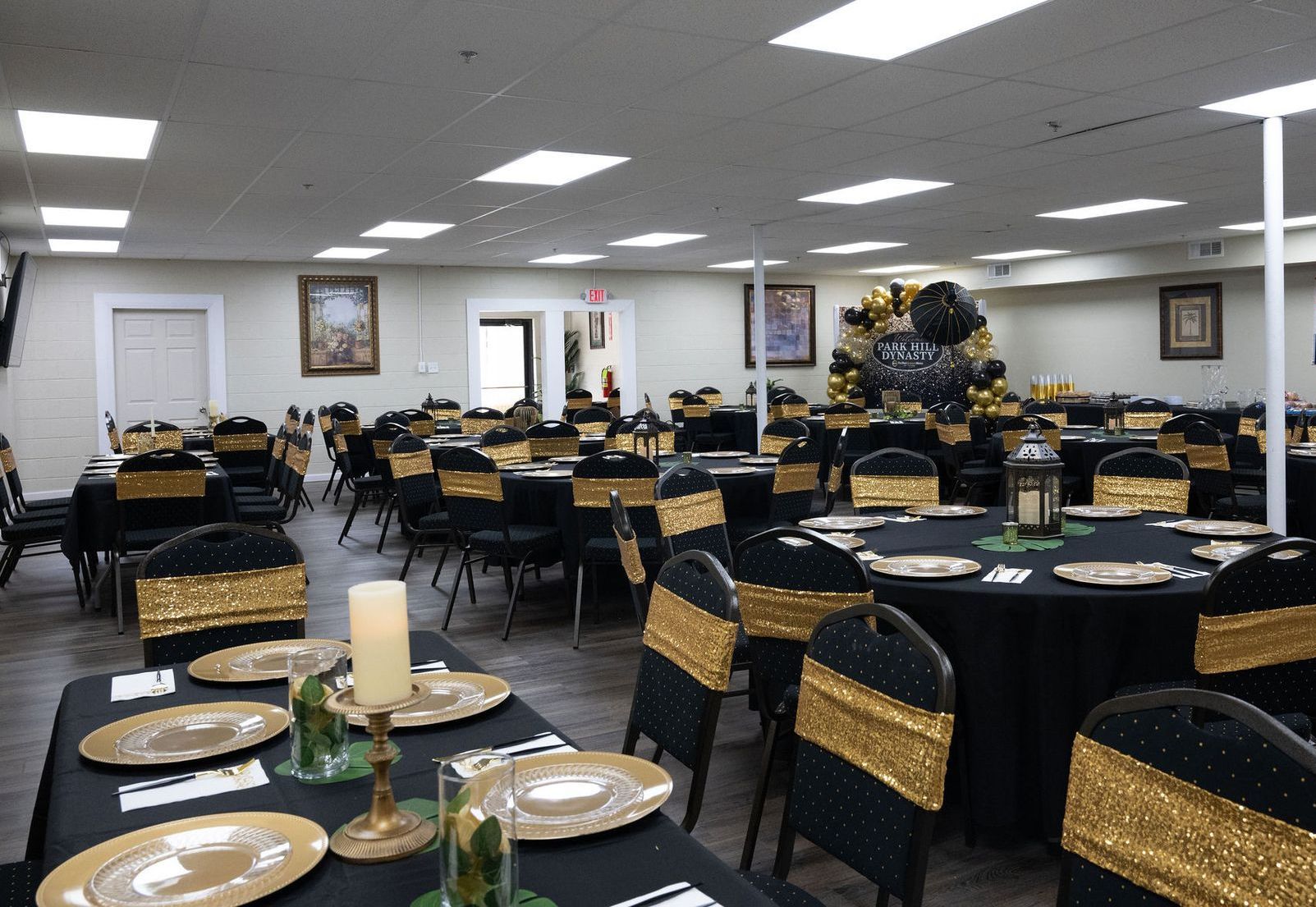 A large room with tables and chairs set up for a party.