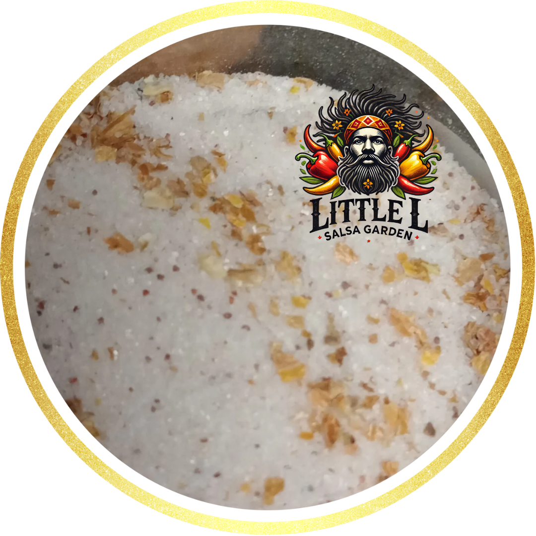 Close-up of white salt with bits of yellow flakes, Little L Salsa Garden logo in a gold circle.