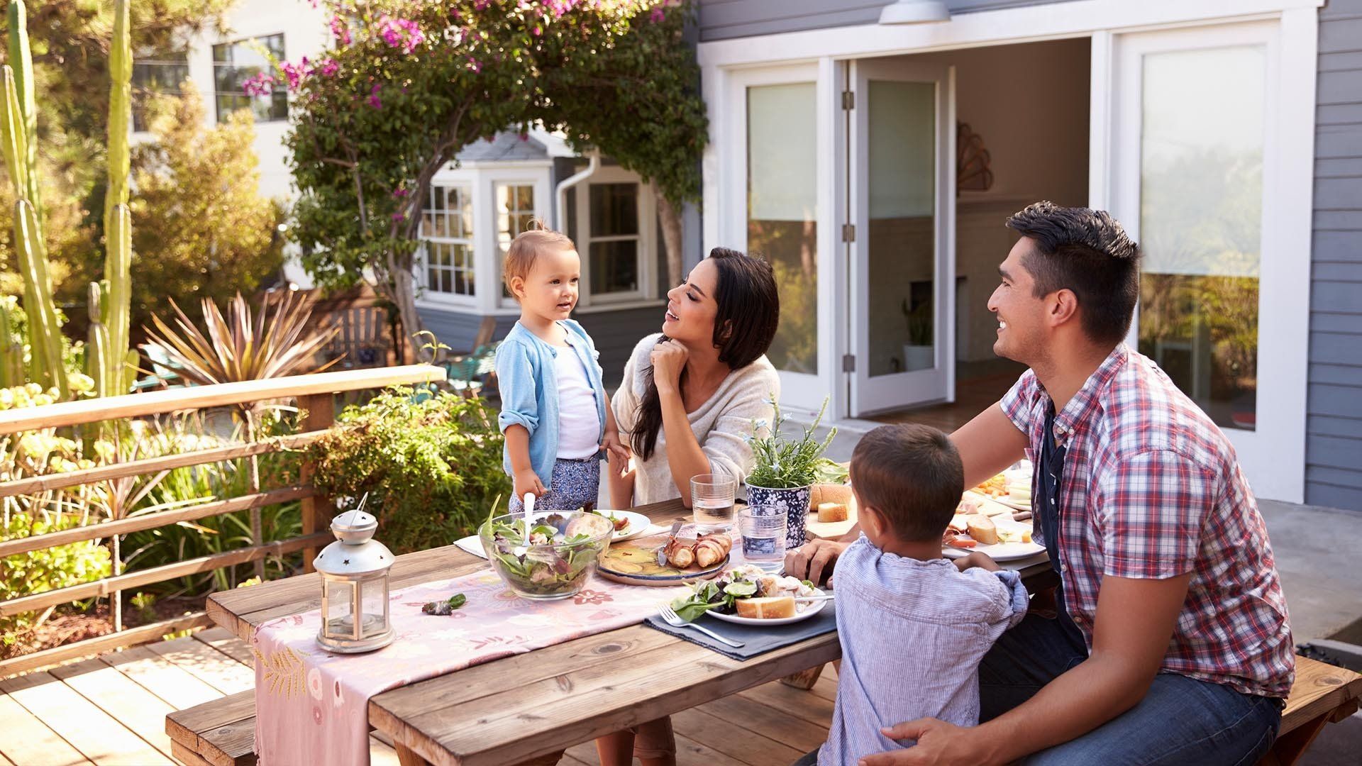 two adults and two children eat dinner