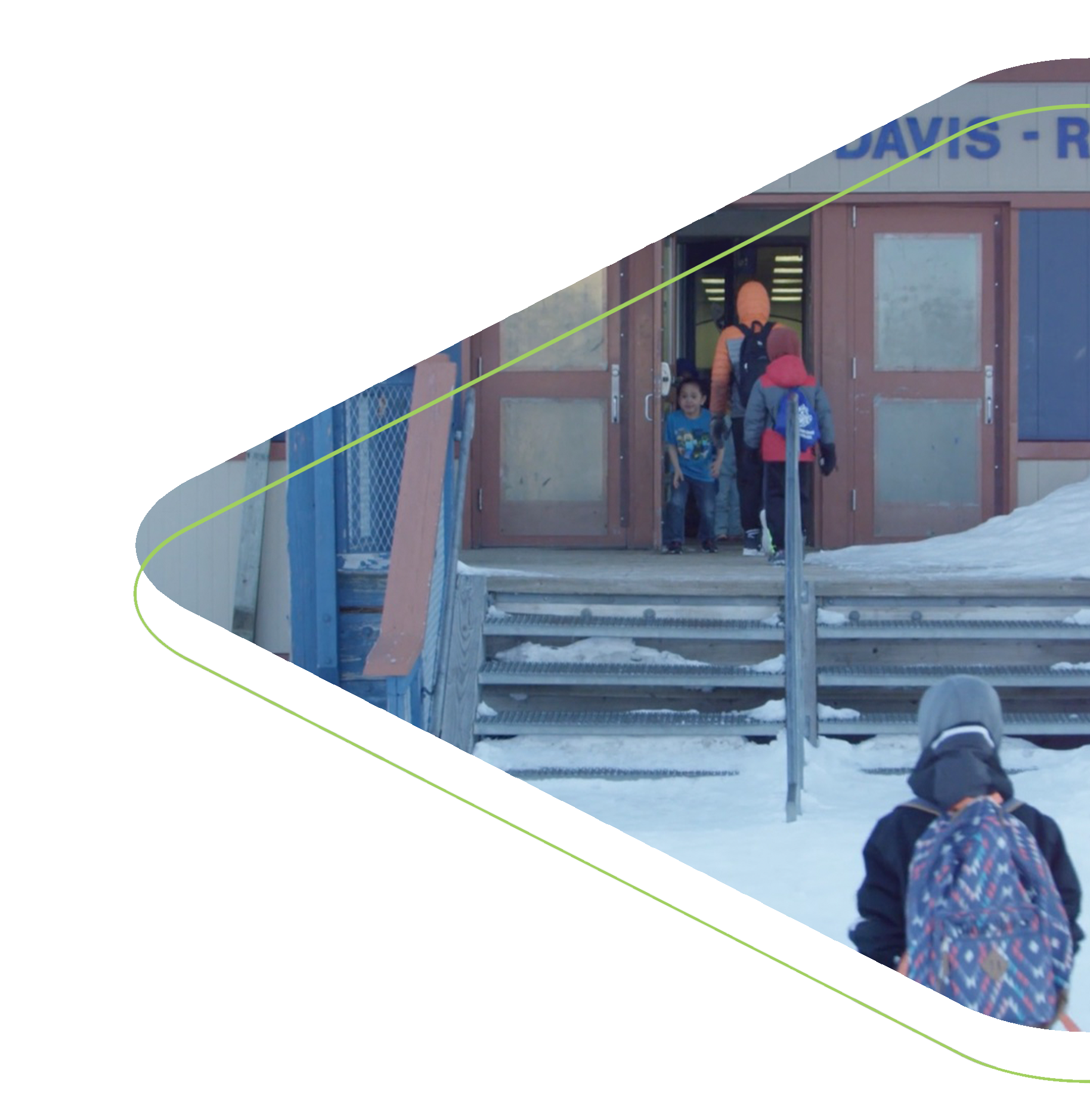 Students walking into school on a snowy winter day