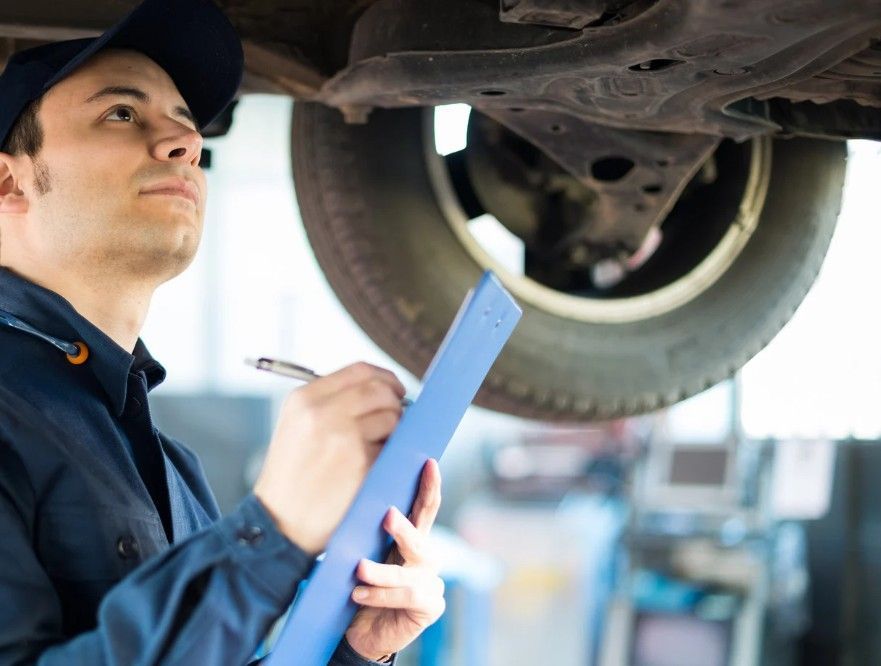 mechanic checking the brakes as part of a car service