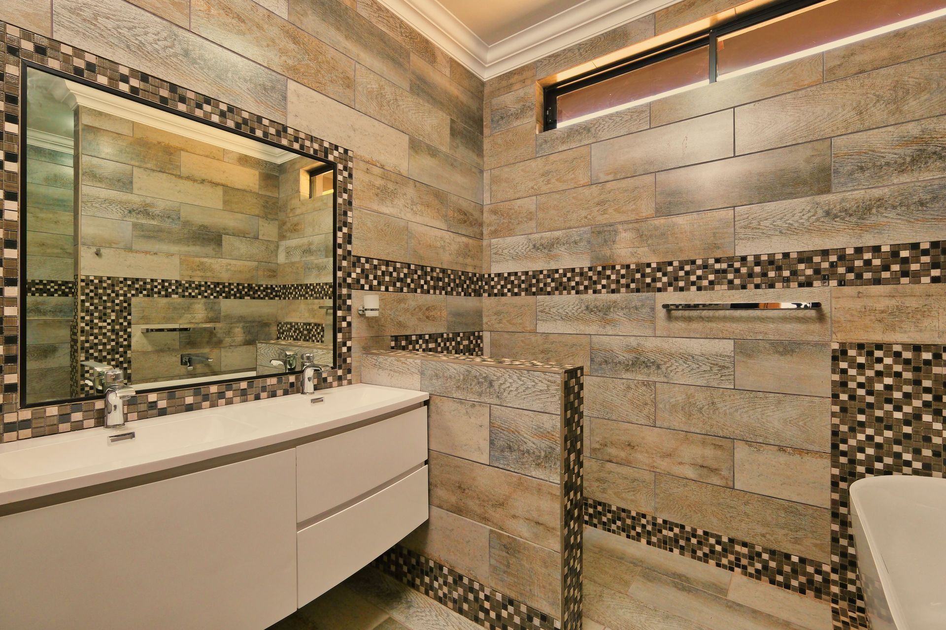 Bathroom with stone-effect wall tiles and a fitted vanity unit