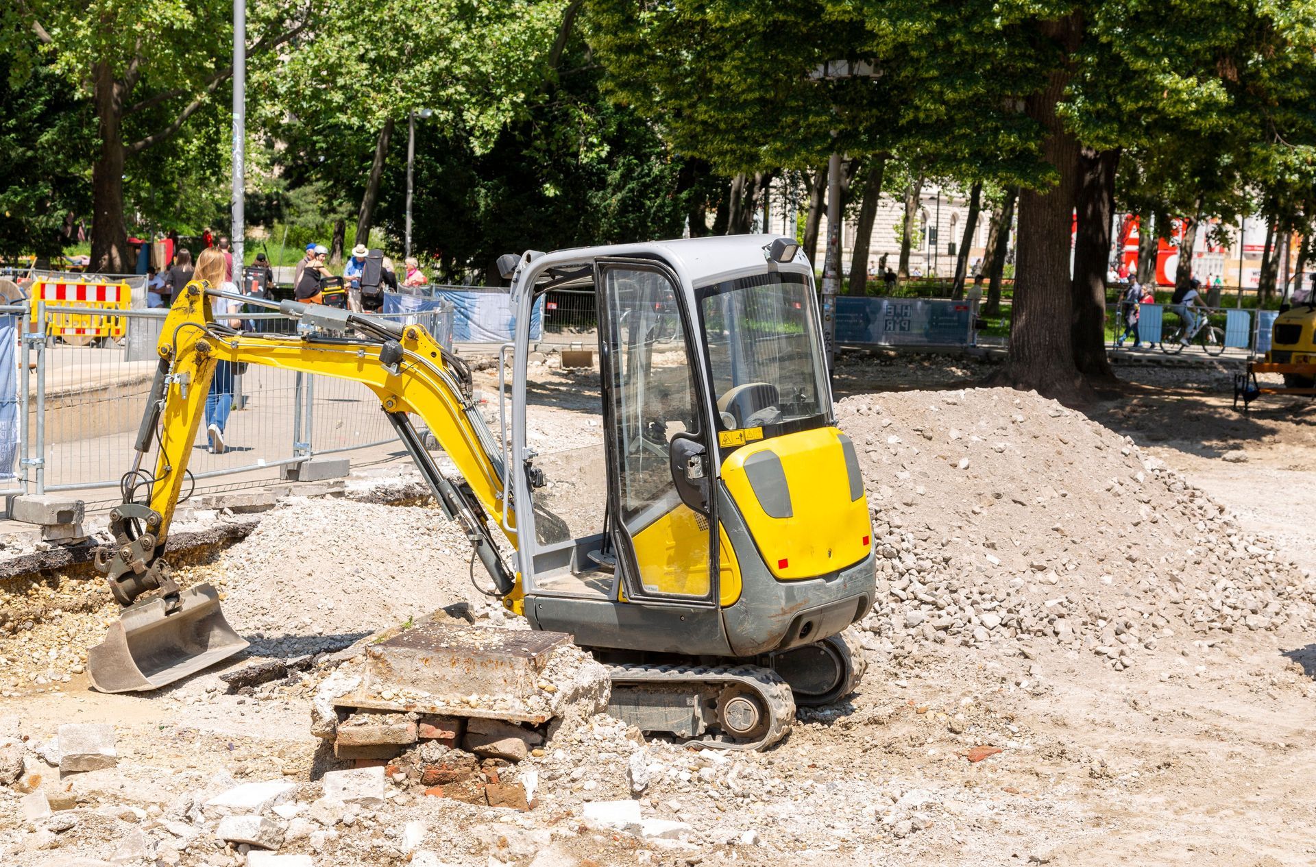 Mini digger excavating ground for a new driveway