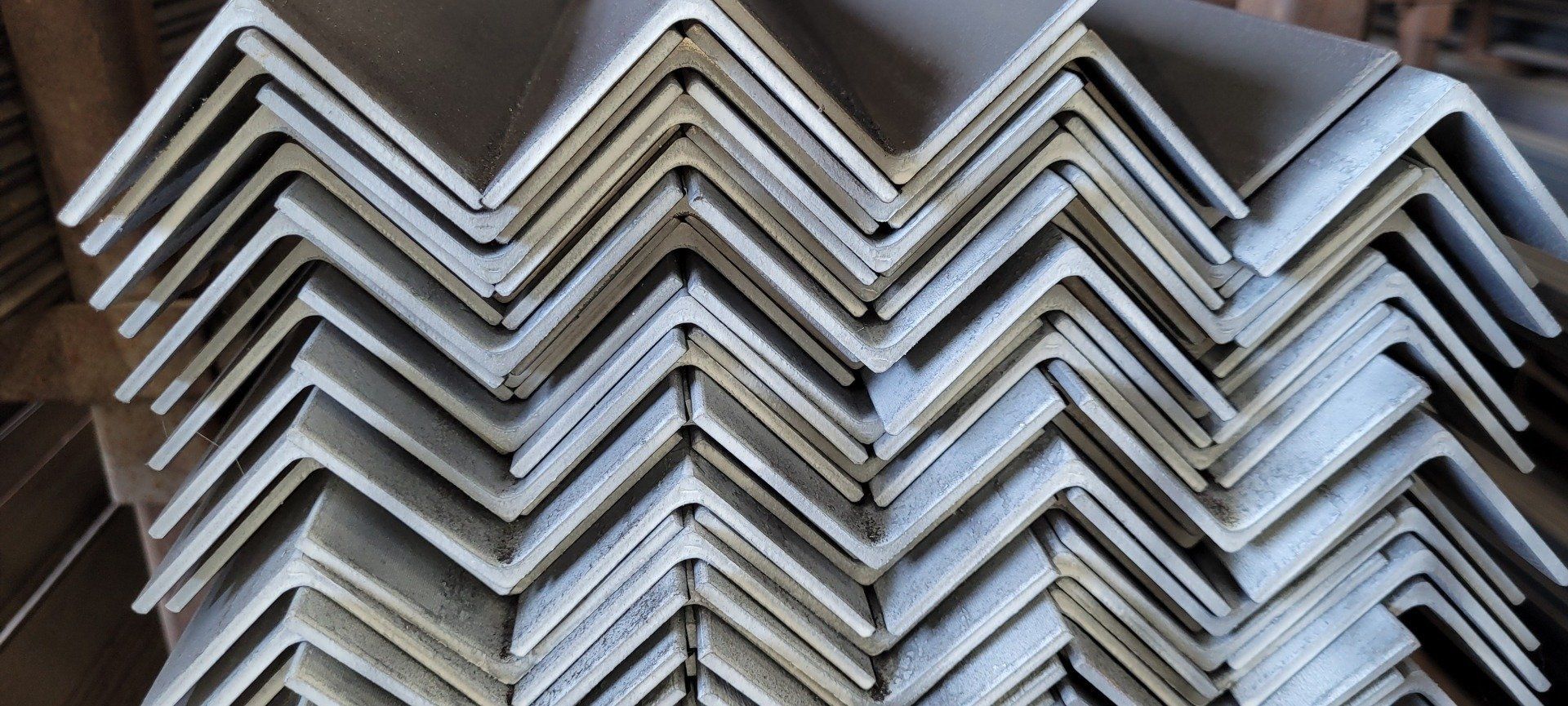 Stacked white zigzag metal panels forming a repeating chevron pattern