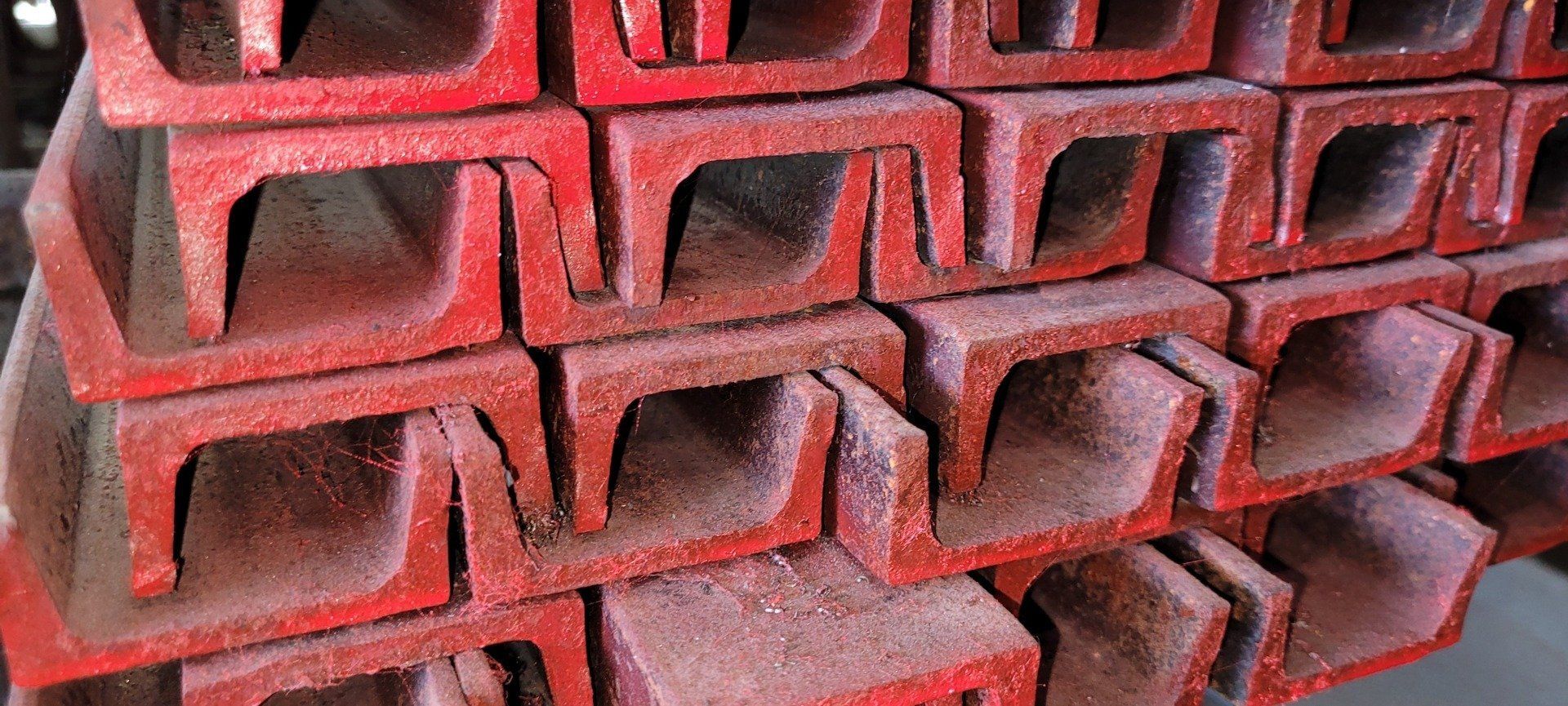 Stacked red concrete blocks with hollow rectangular openings