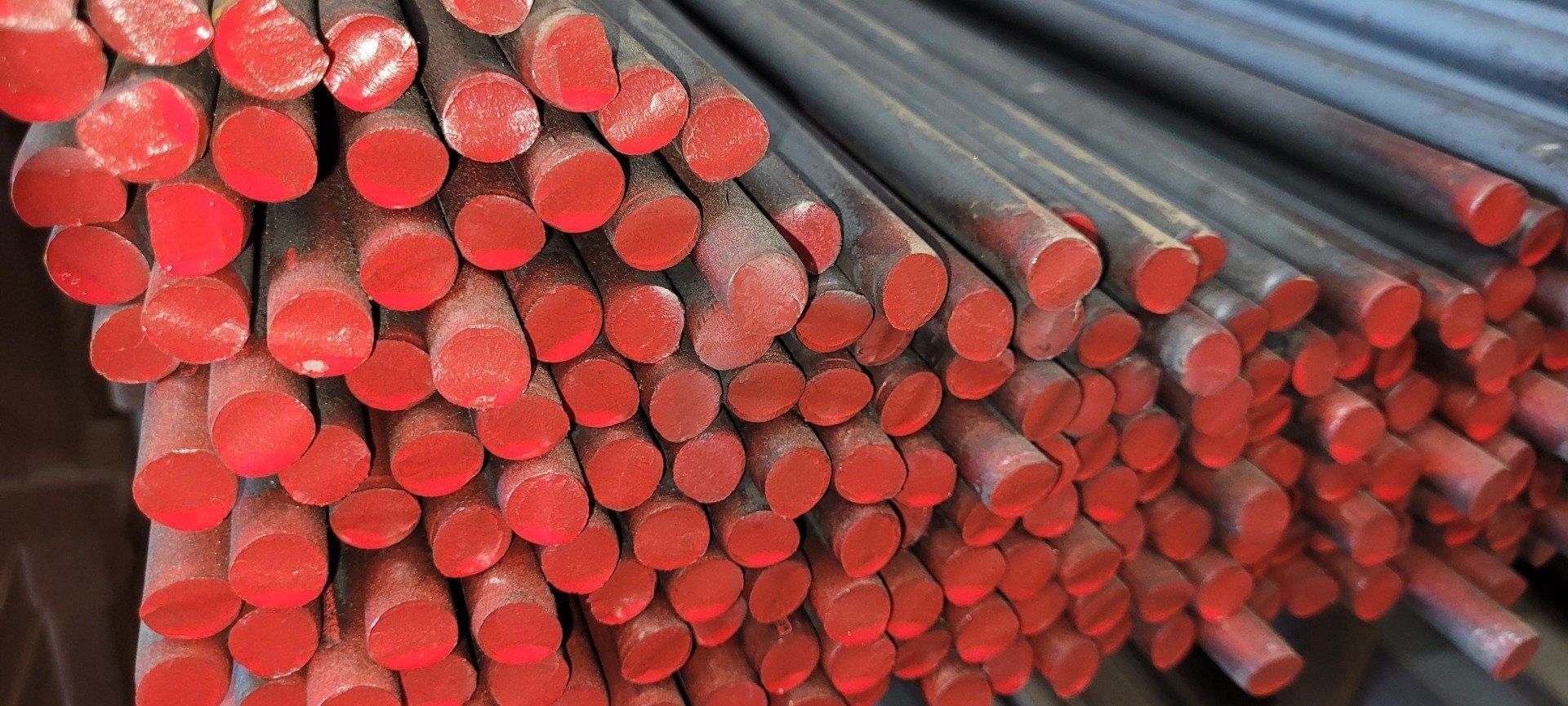 Bundle of red-tipped metal rods stacked together