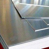 Stainless steel kitchen hood with a smooth, brushed metal finish and geometric panel lines