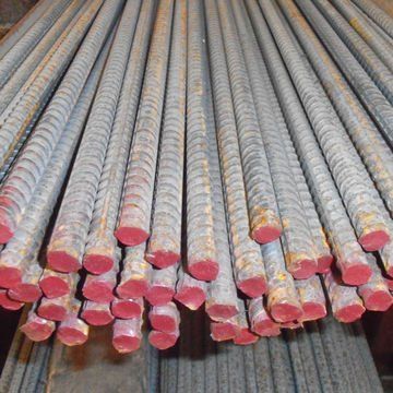 Stacked steel rebar rods with red-painted ends, viewed from above