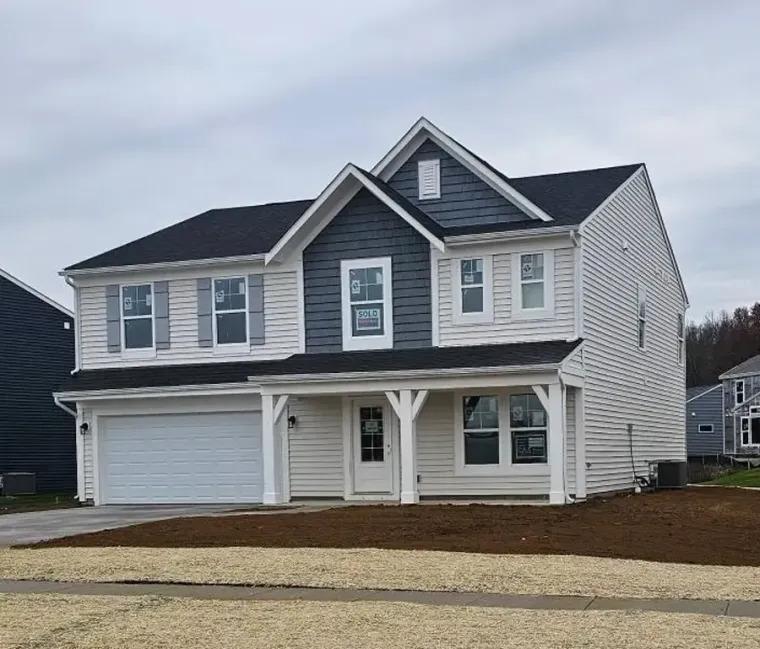 Two modern houses with gray siding and black trim on a sunny day, viewed from the front lawn.