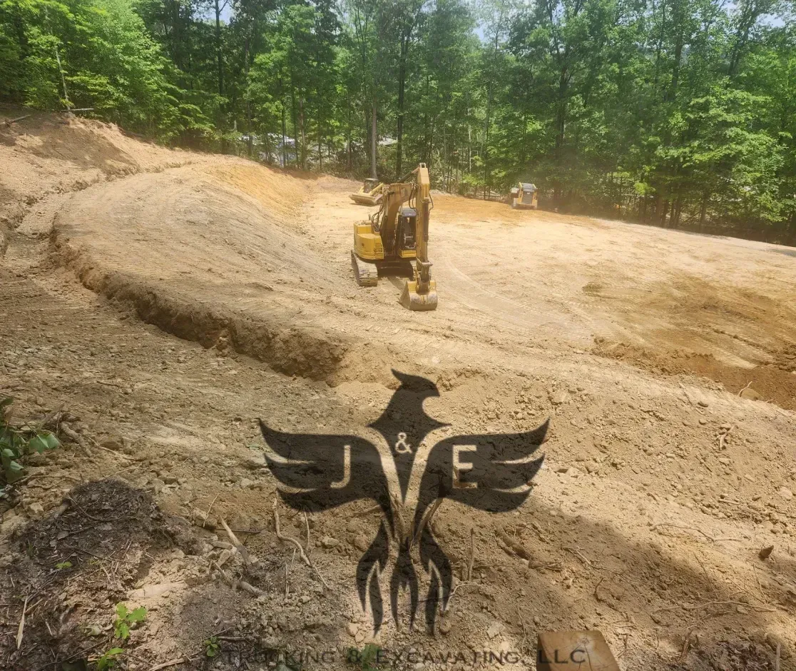 Bulldozer on a dirt slope with a large black eagle emblem in the foreground