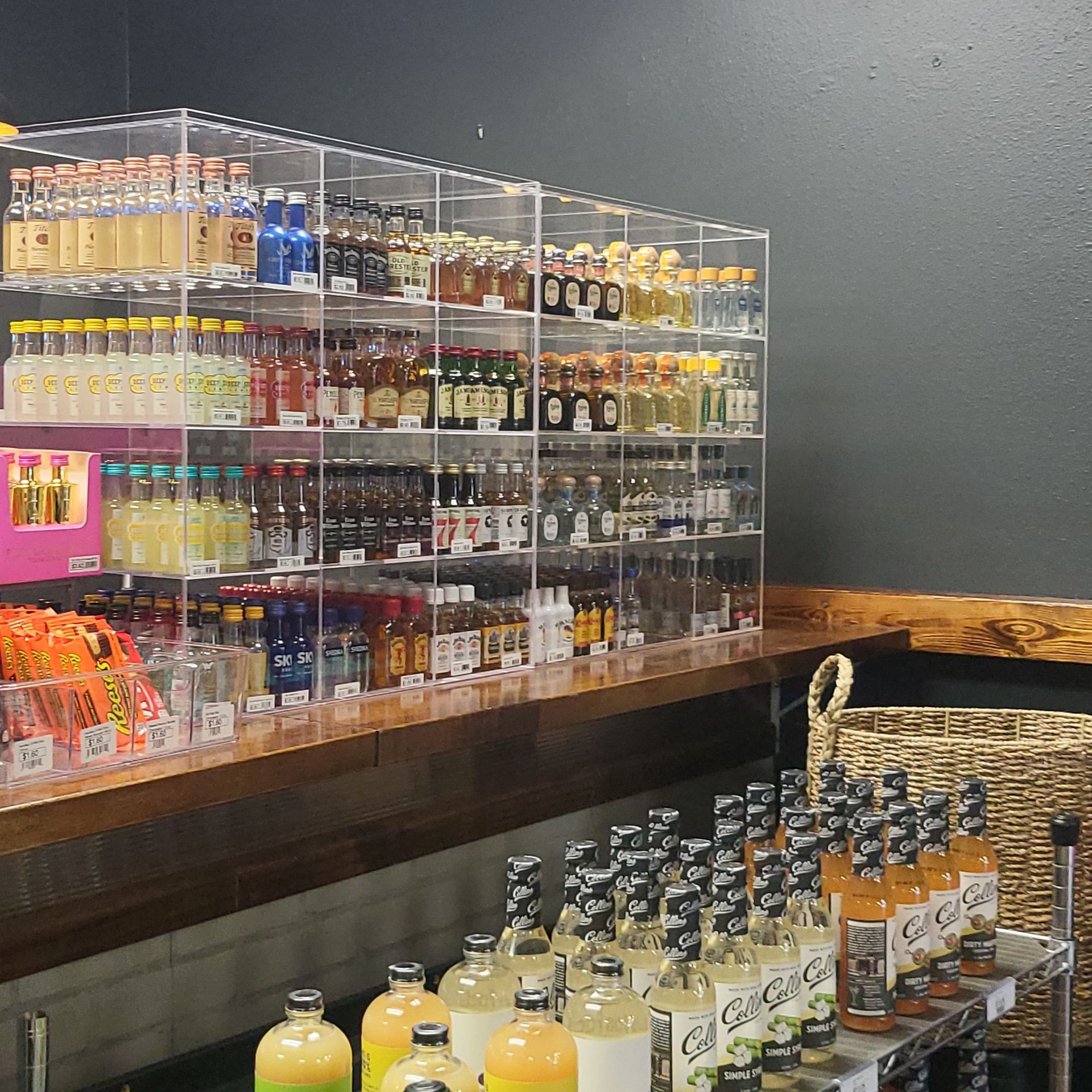 Shelves of assorted bottled drinks and snacks in a convenience store cooler area