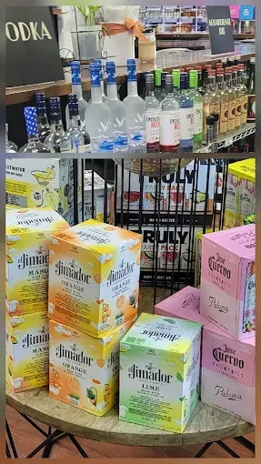 Liquor store display with assorted vodka bottles and colorful boxed drinks on shelves