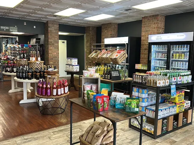 Grocery store aisle with shelves of snacks, drinks, and gift items on display.