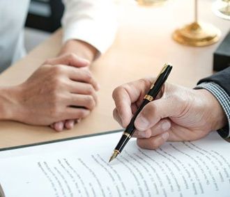 Legal counsel presents to the client a signed contract with gavel and legal law