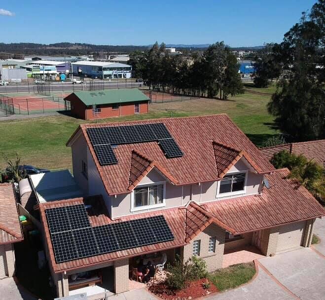 An Aerial View of a House With Solar Panels on the Roof — Spot On Solar International in Newcastle, NSW