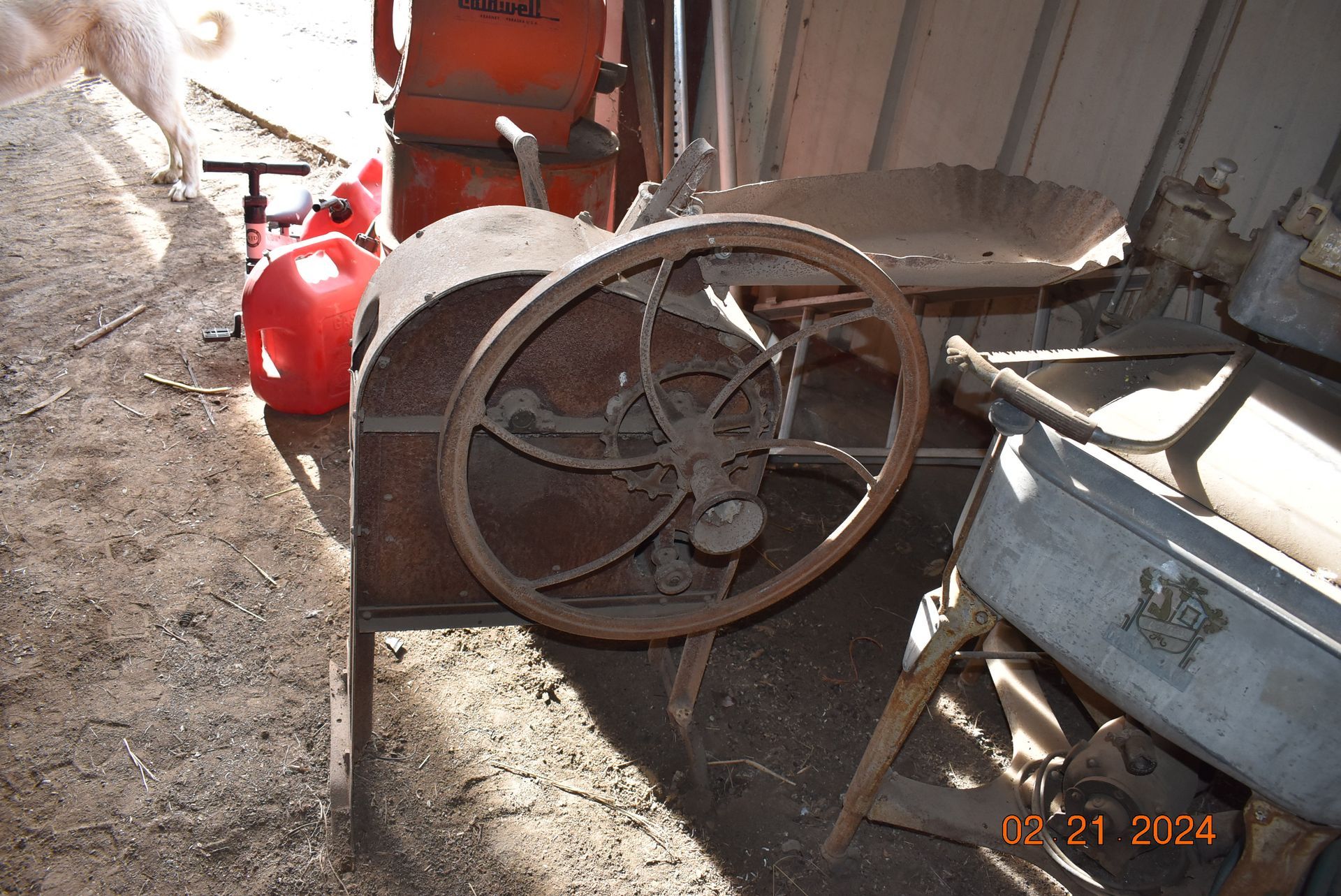 Antique farm machinery turning wheel.