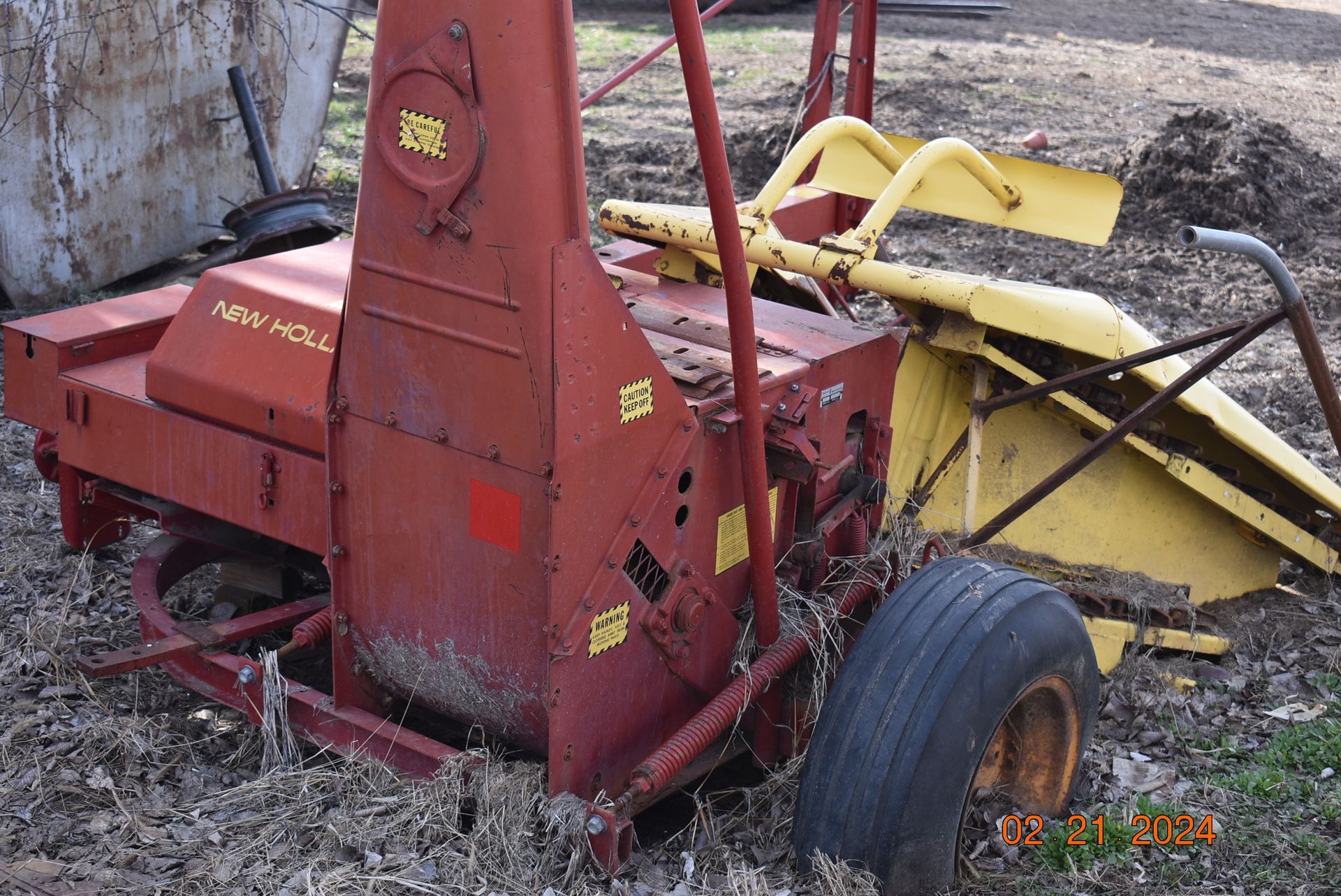 a red and yellow machine with the word new holland on it