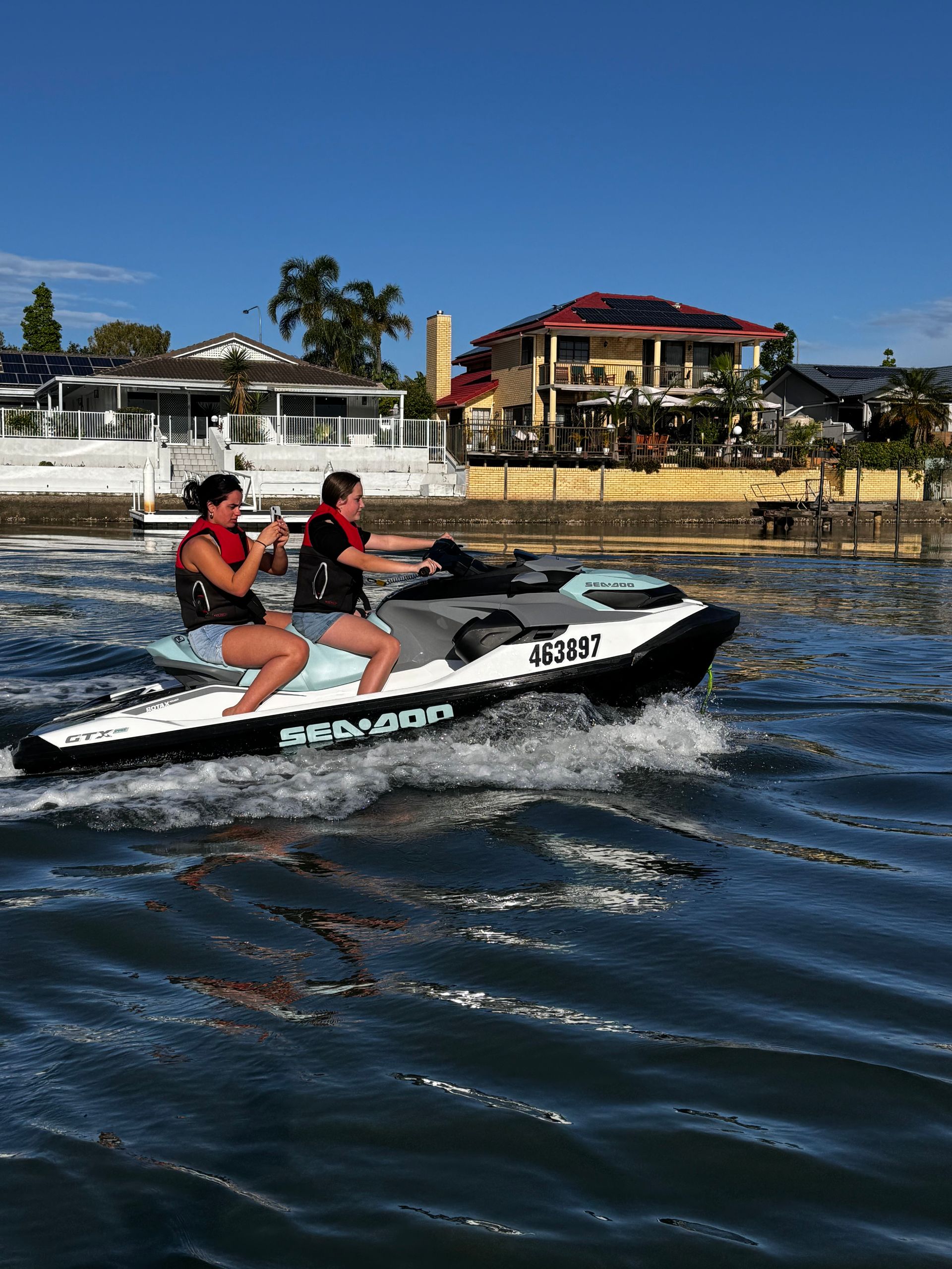Two people are riding a jet ski in the water.