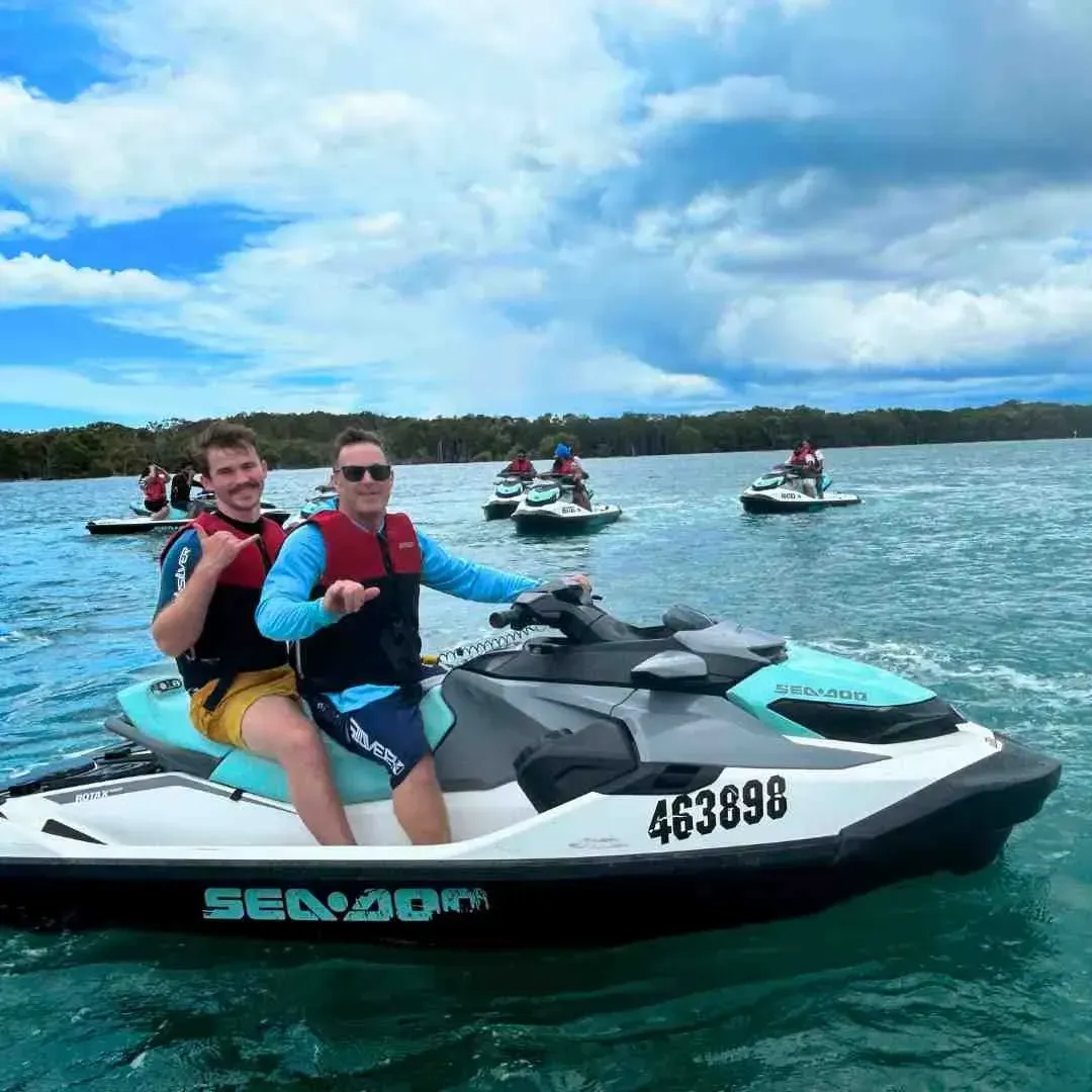 Gold Coast marine tours - A group of friends riding jet skis they hired, each jet ski holding 2 people. Gold Coast marine tours - A group of friends riding jet skis they hired, each jet ski holding 2 people.