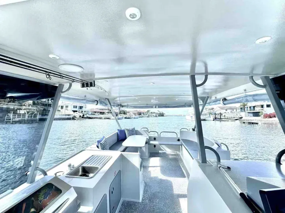 The spacious and comfortable onboard BBQ and seating area of a GC Jet Ski pontoon boat, ready for a party. - Full day vs half day pontoon hire The spacious and comfortable onboard BBQ and seating area of a GC Jet Ski pontoon boat, ready for a party. - Full day vs half day pontoon hire