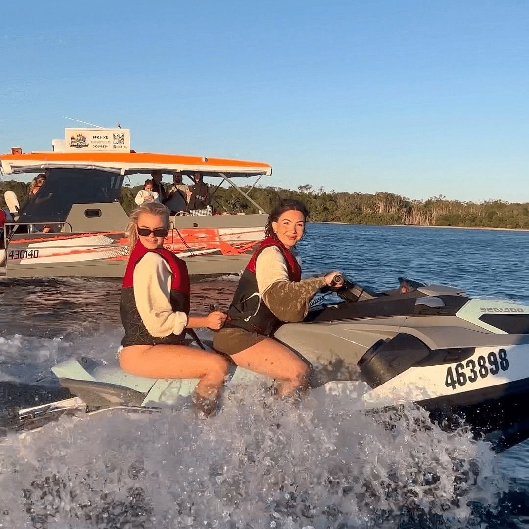 Two women are riding a jet ski in the water.