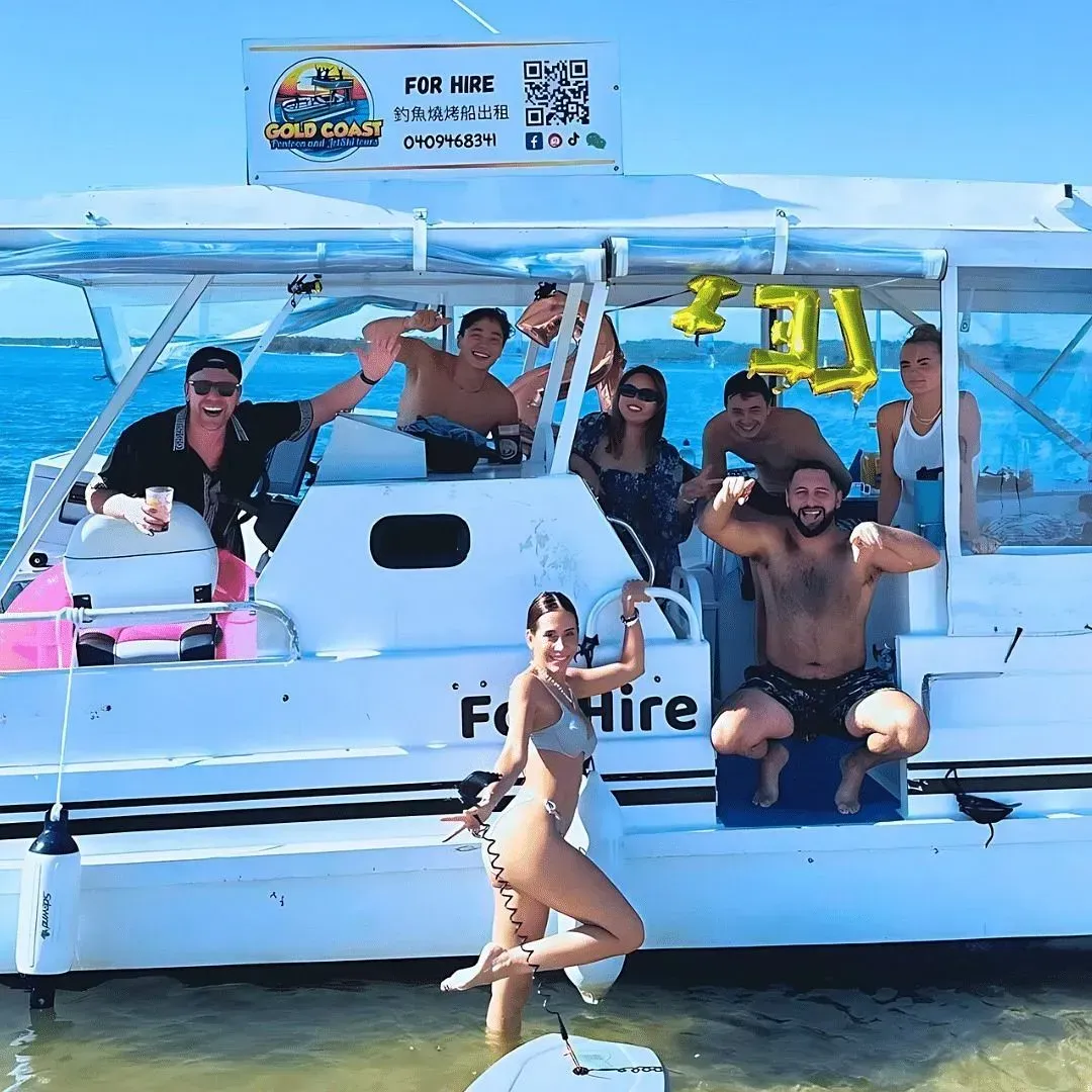 Group of friends on a white boat, posing, smiling, celebrating. Sunny day at the beach, 