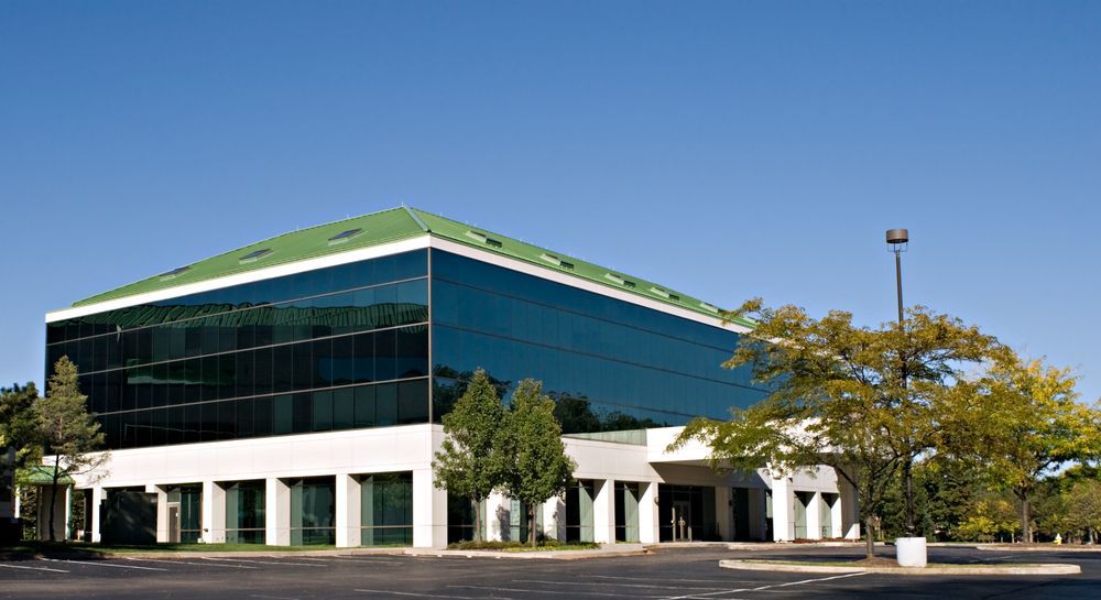 A Large Building With A Green Roof And A Lot Of Windows — Jay's Tint in Cairns, QLD