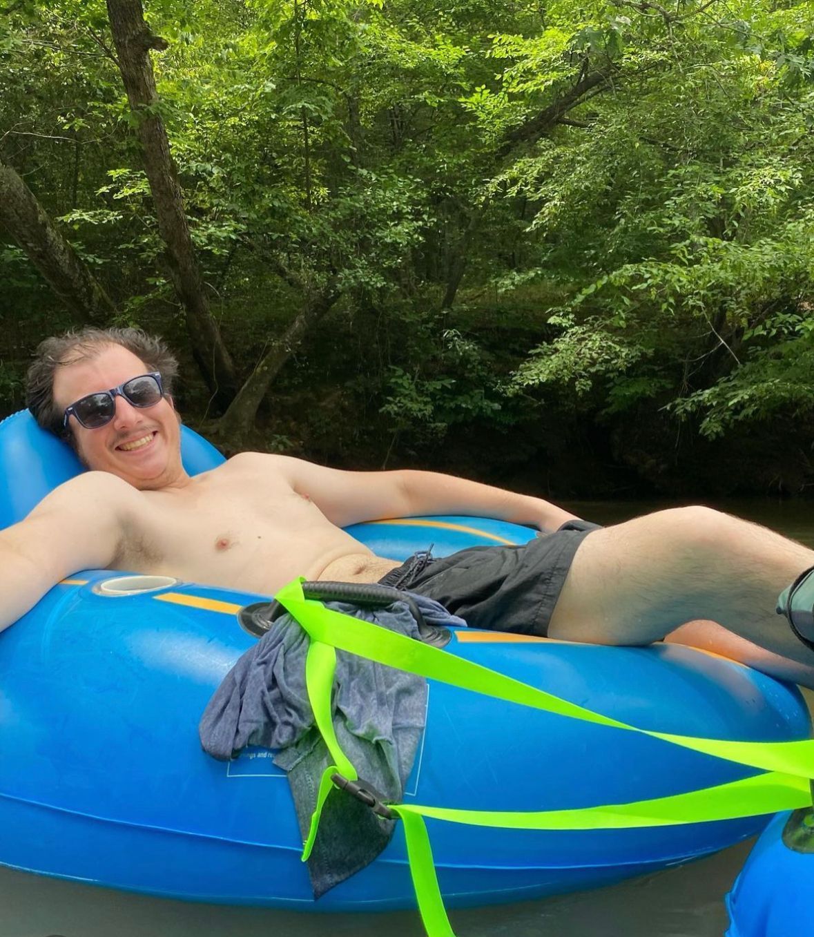 Person floating on a tube with Saluda Outdoor River Company on the Saluda River in Greenville, SC