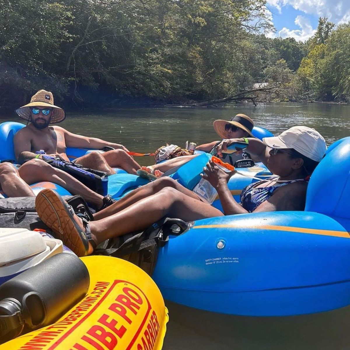 Group of people floating on tubes with Saluda Outdoor River Company on the Saluda River in Greenville, SC