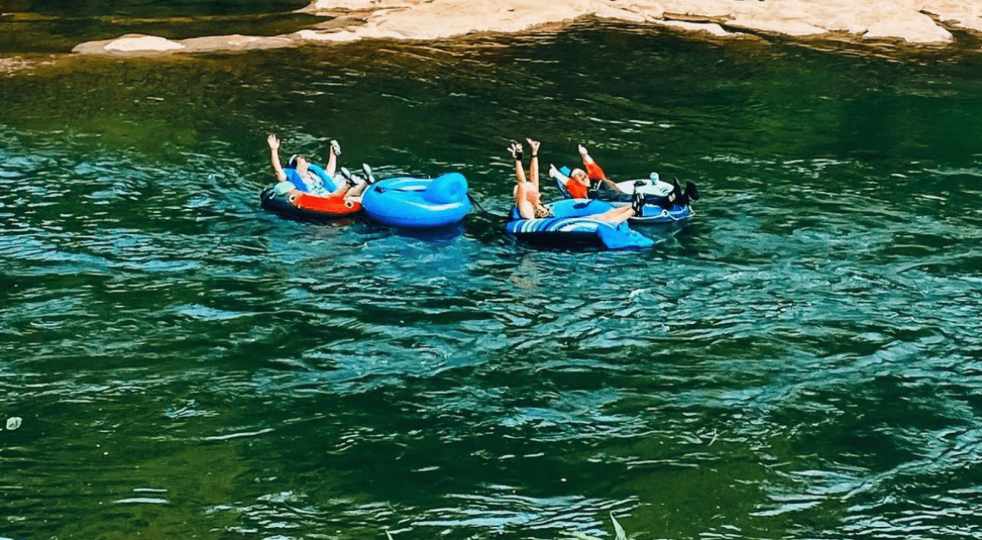 Group of people floating on tubes with Saluda Outdoor River Company on the Saluda River in Greenville, SC