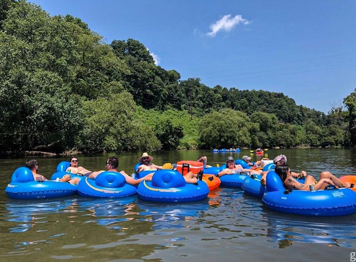 Group of people floating on tubes with Saluda Outdoor River Company on the Saluda River in Greenville, SC