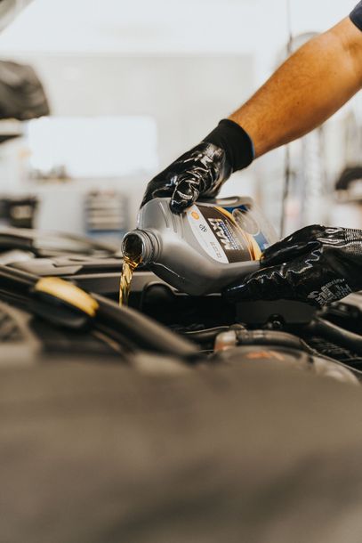 Fresh Motor Oil Being Poured During Service | Burtonsville Automotive Services