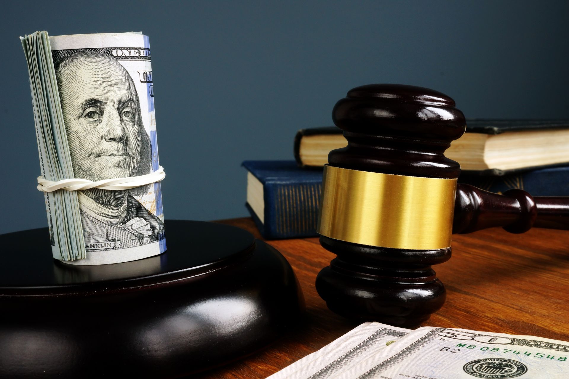 A judge's gavel and cash on a desk, representing bail bonds and legal justice. A judge's gavel and cash on a desk, representing bail bonds and legal justice.
