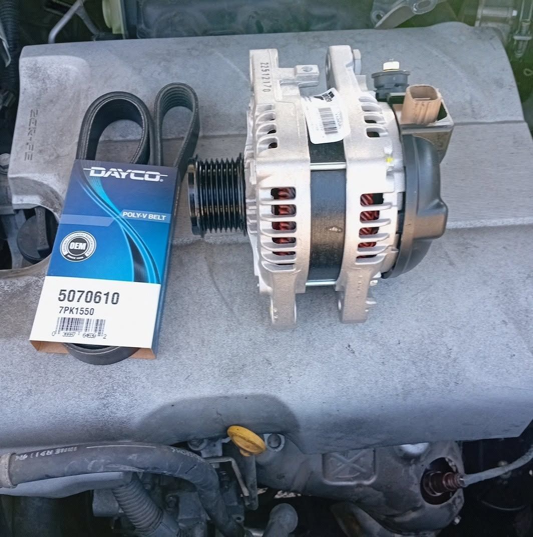 Car alternator with serpentine belt and packaging on an engine cover, viewed from above
