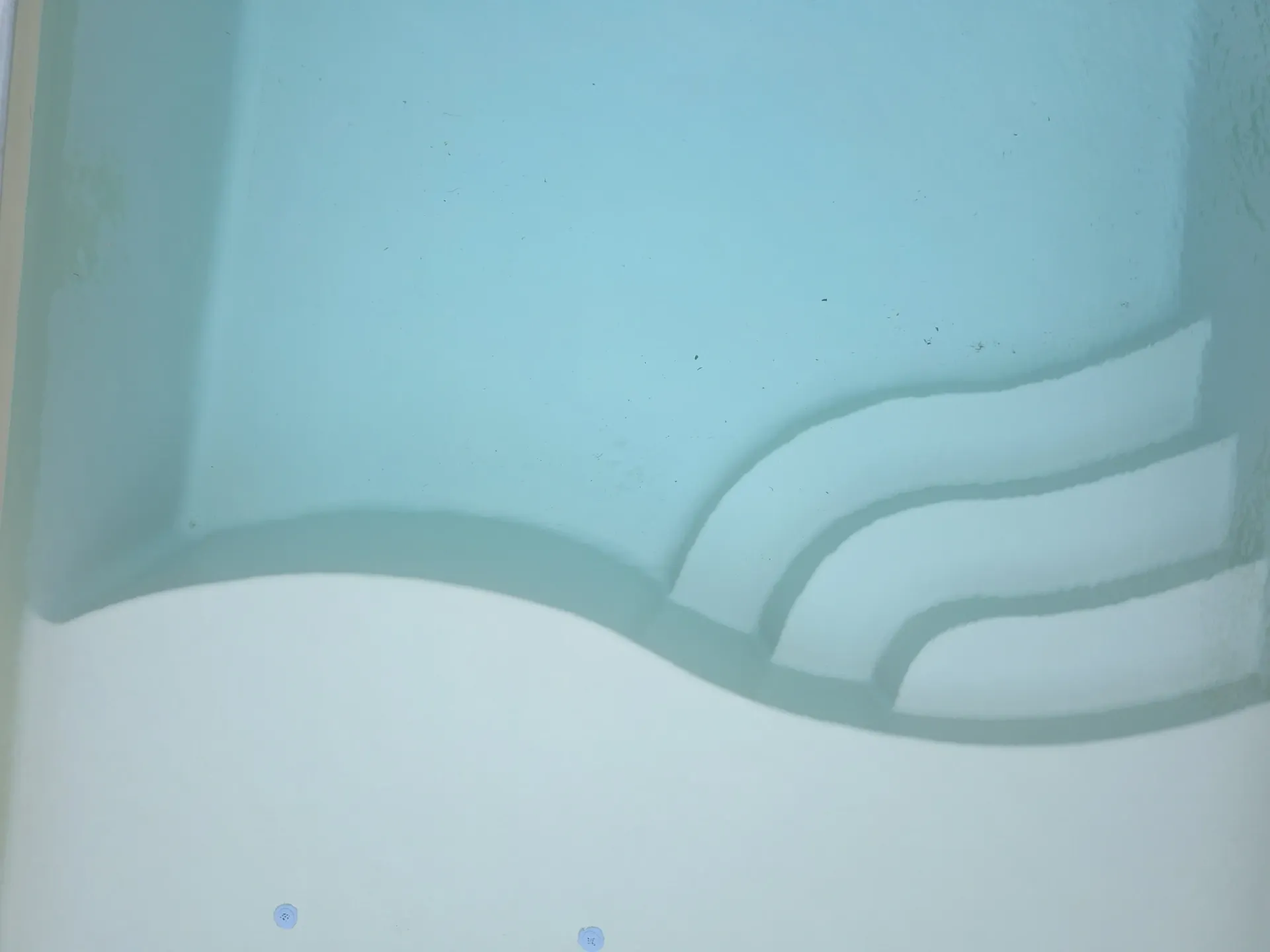 Light blue wall with a white wavy border and layered curved trim near the bottom