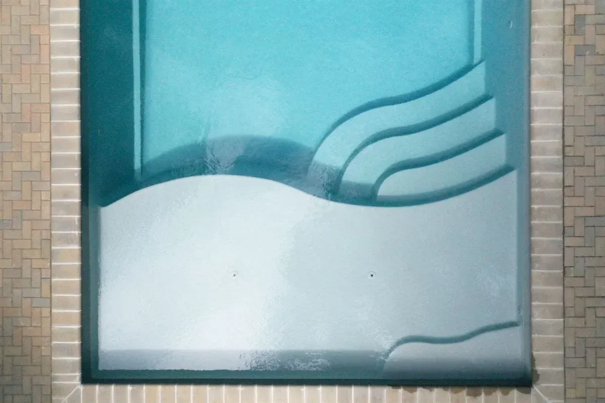 Abstract teal and white wall art with curved lines and a tiled border