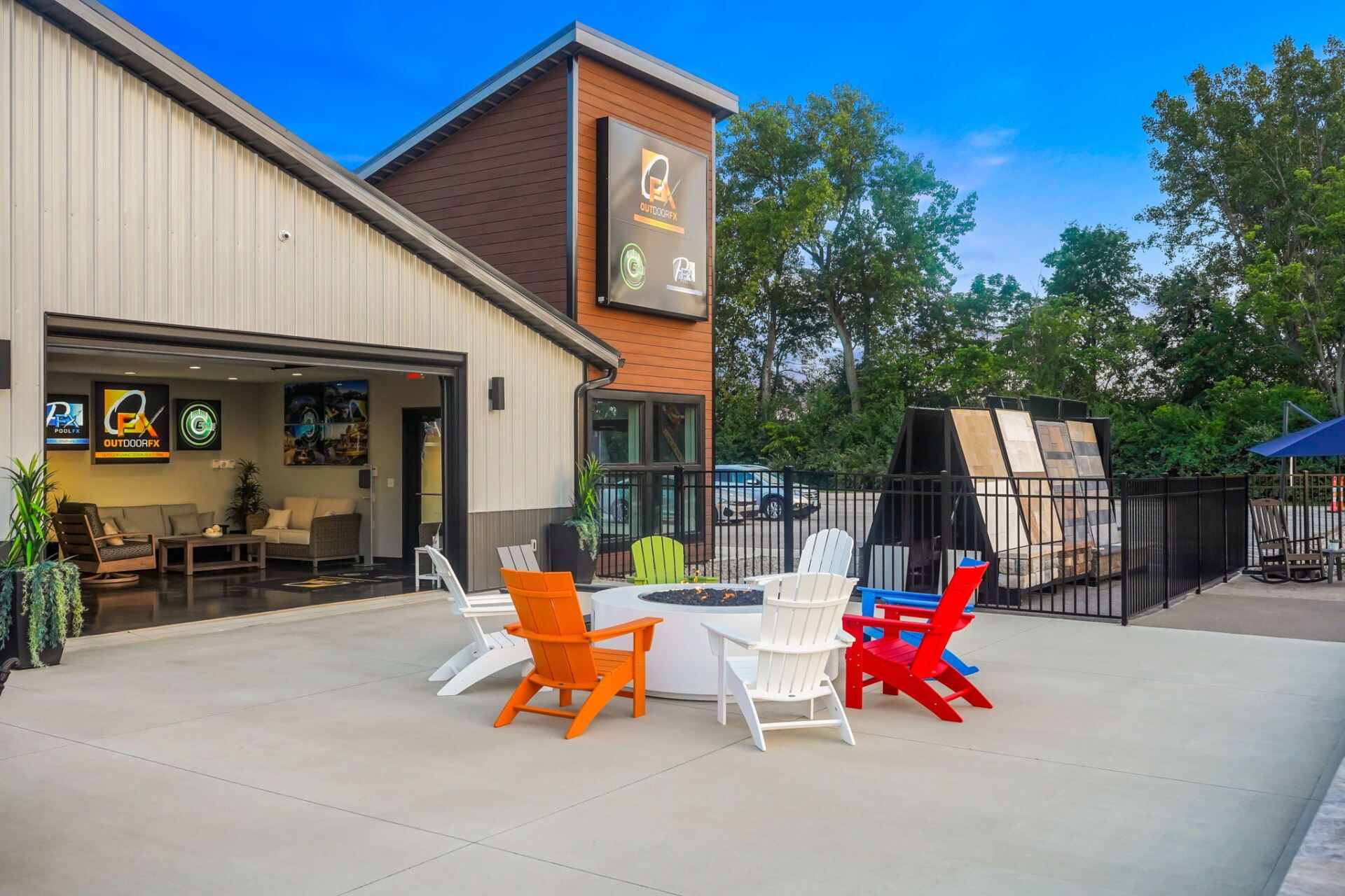 Outdoor patio with colorful chairs outside a modern brewery building
