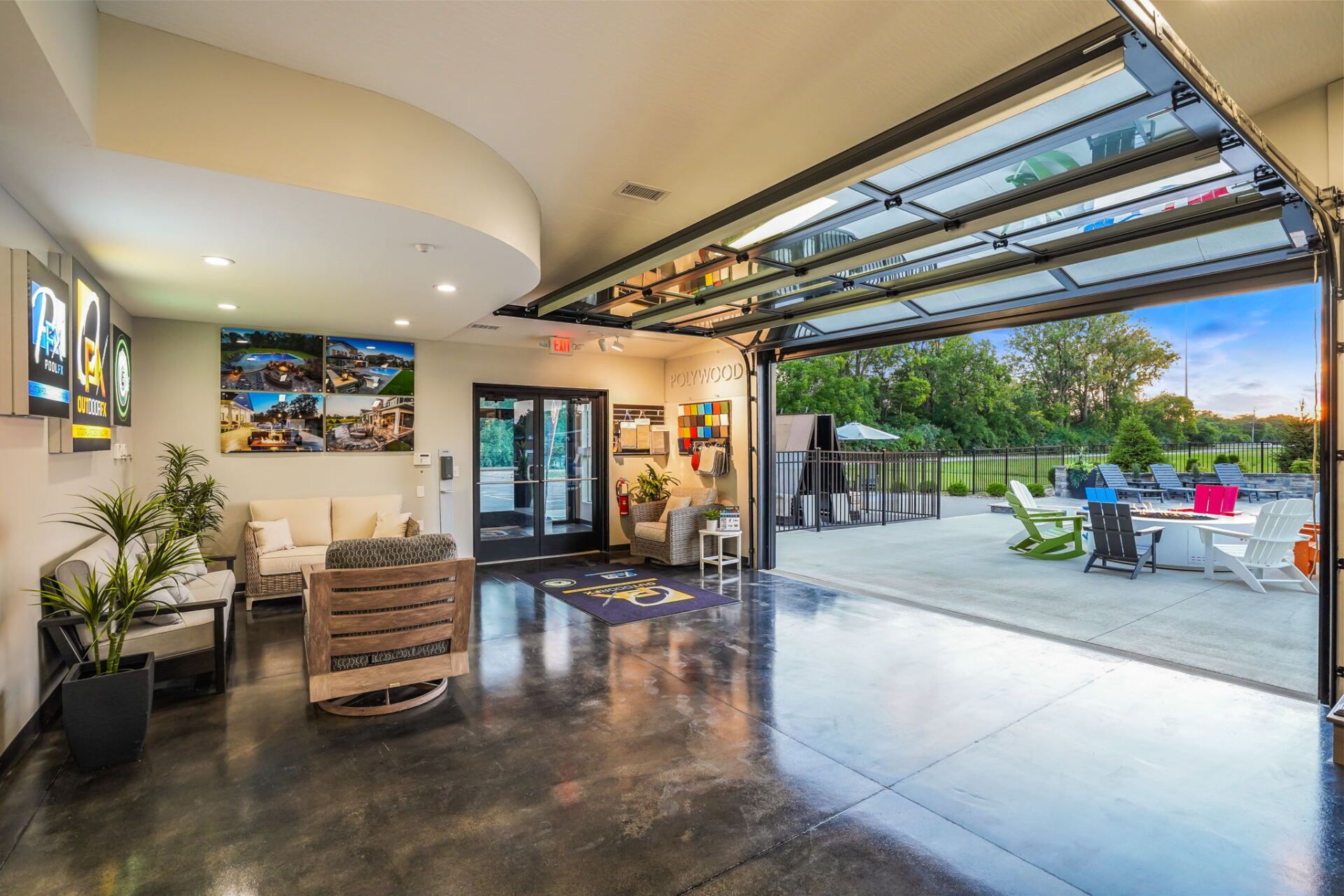 Open-air patio lounge with polished floor, bar seating, and garage doors opening to an outdoor dining area.