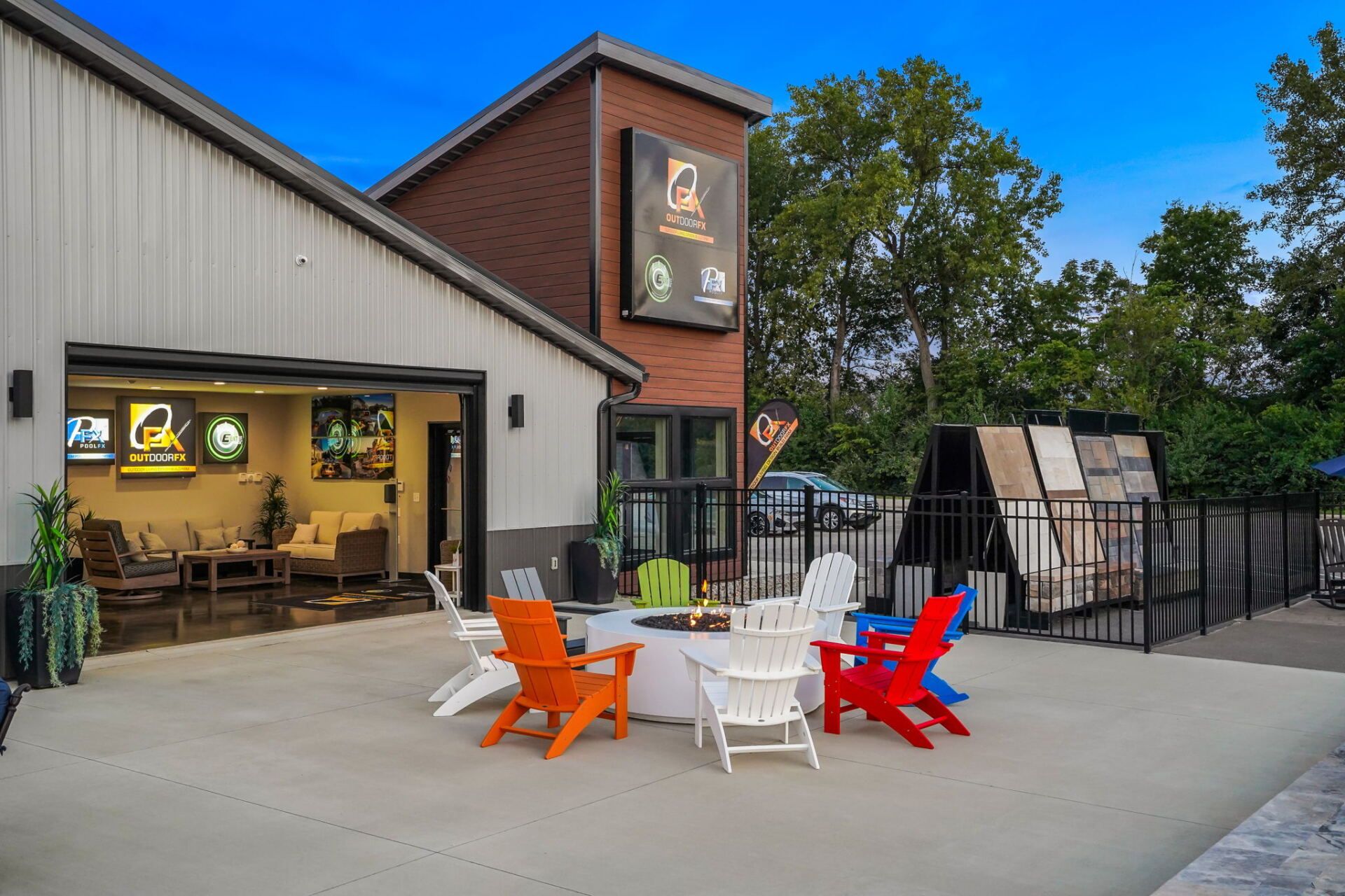 Outdoor patio with colorful chairs outside a café-like building and open garage-style seating area