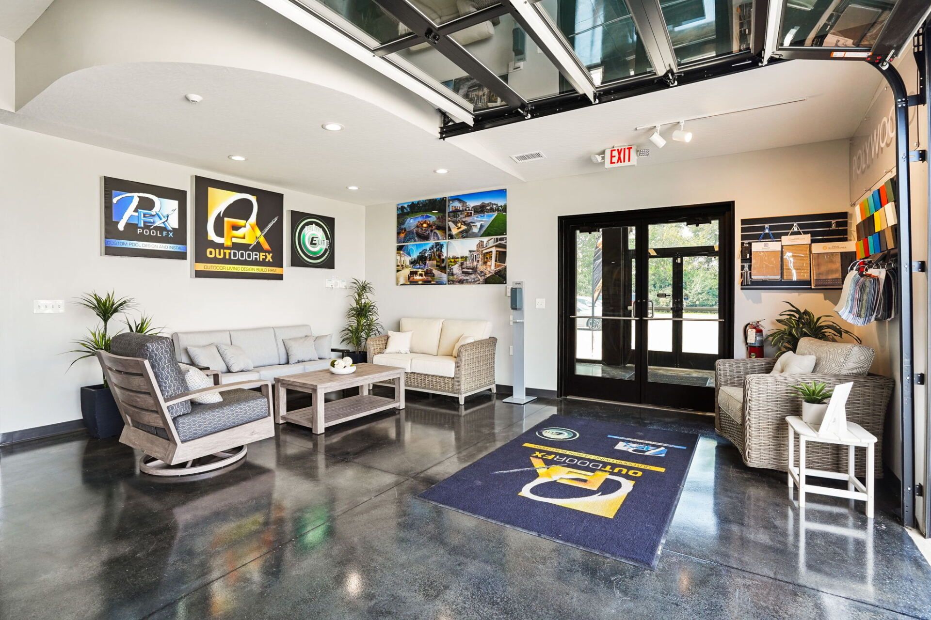Modern lobby with gray seating, wall art, polished floor, and a glass entrance door