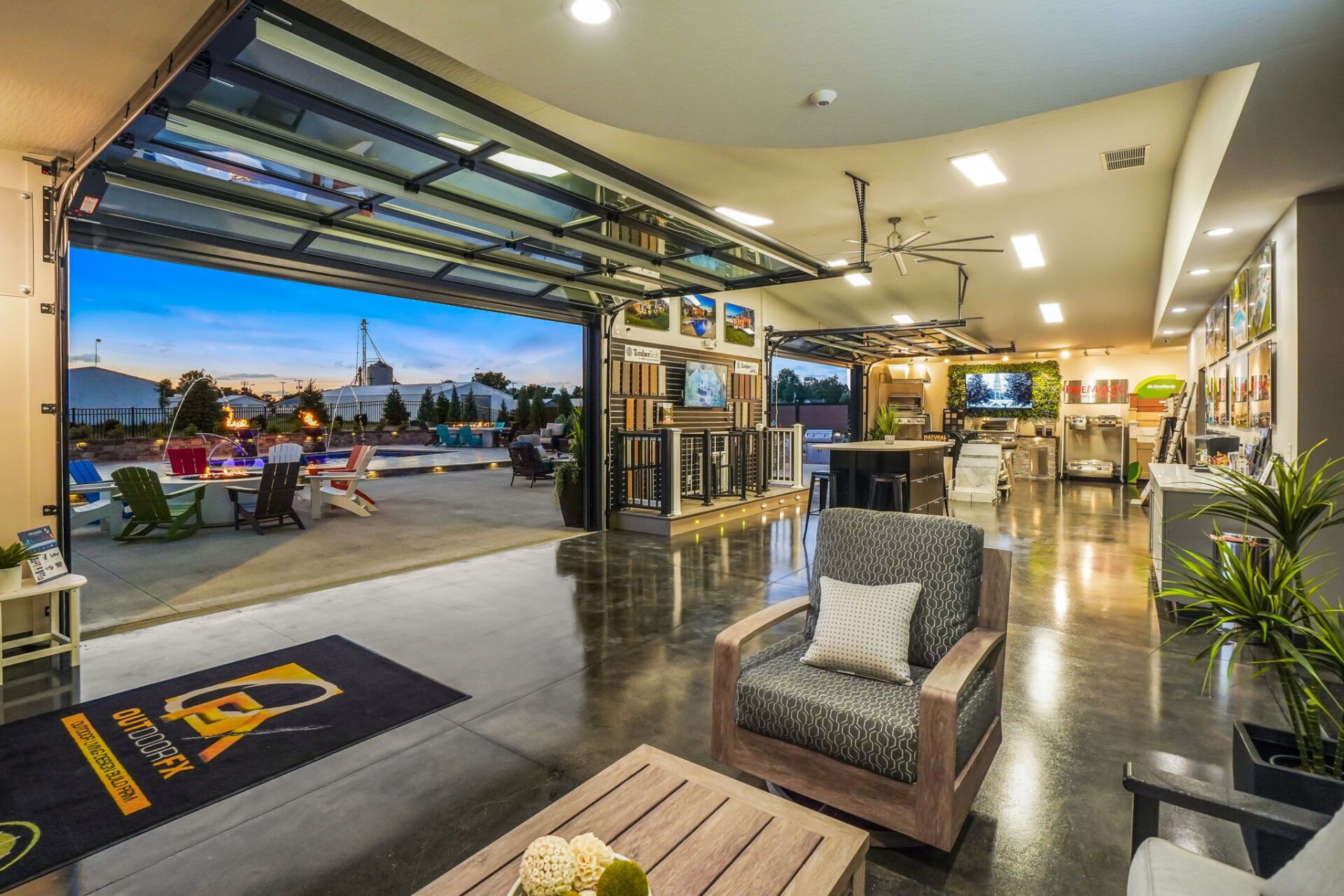 Modern hotel lobby with open-air seating, polished floors, and a sunset view outside