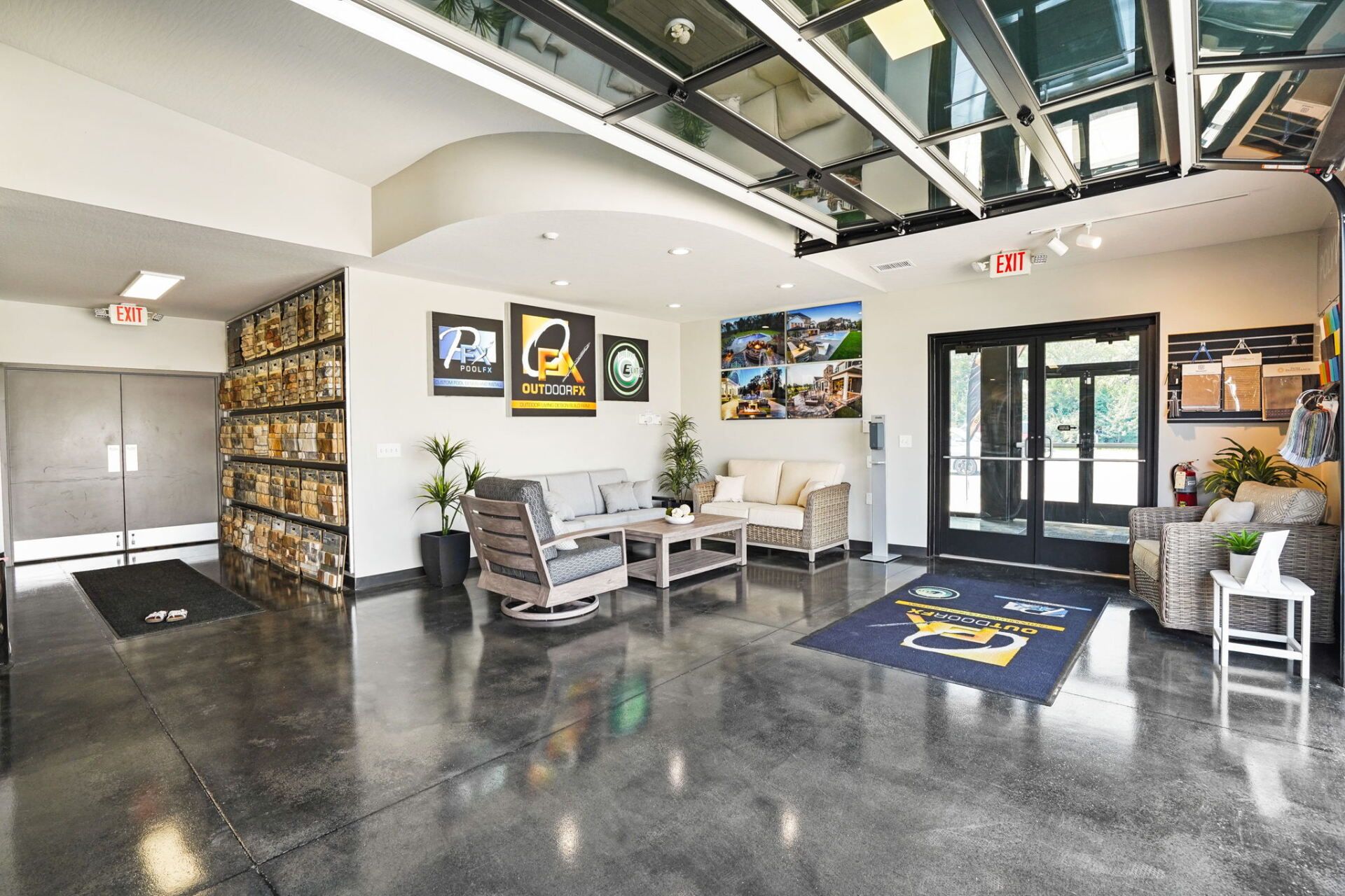 Modern office lobby with polished concrete floor, seating area, and glass entrance doors