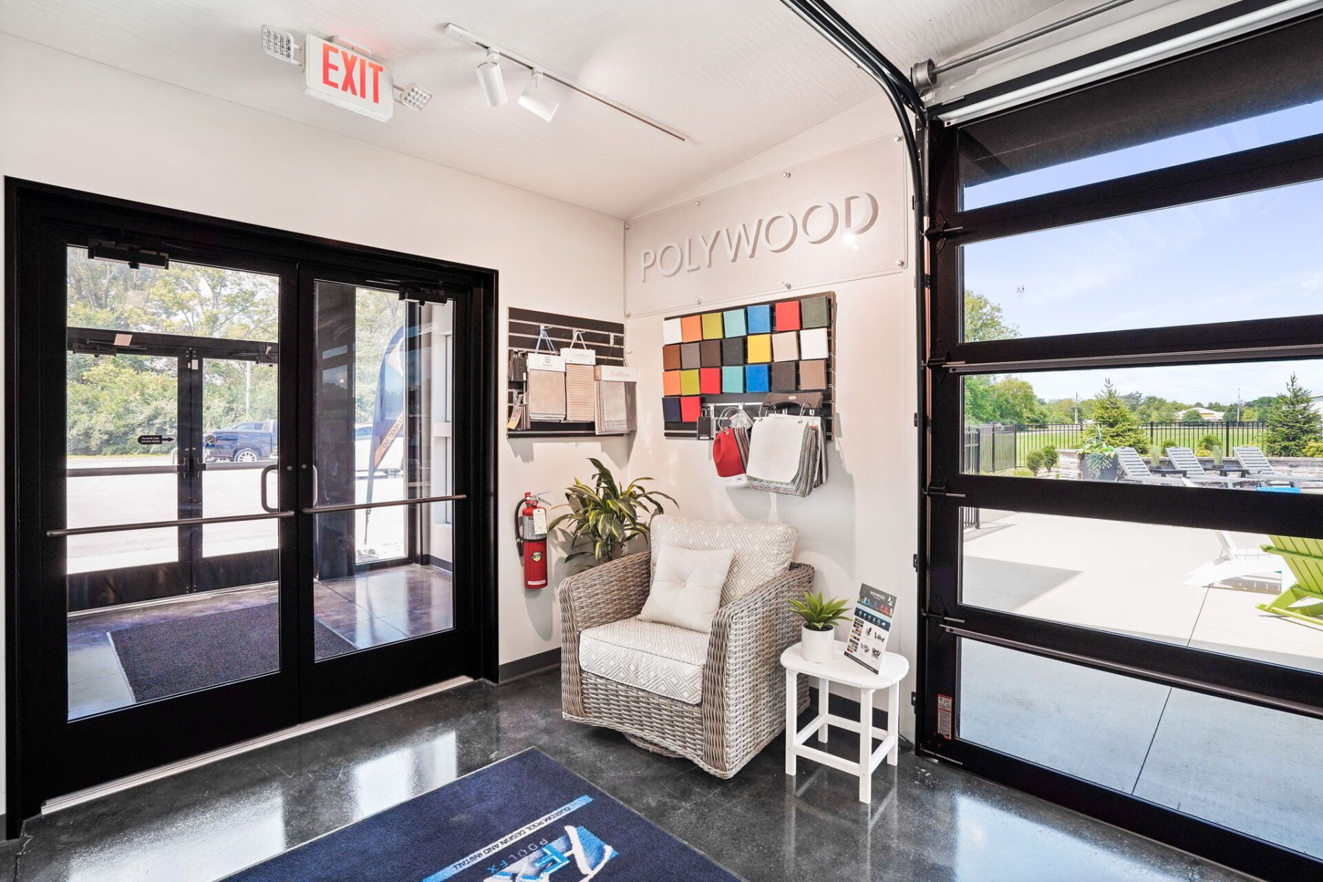 Bright lobby with glass doors, white chair, colorful wall art, and “COWOOD” lettering on the wall