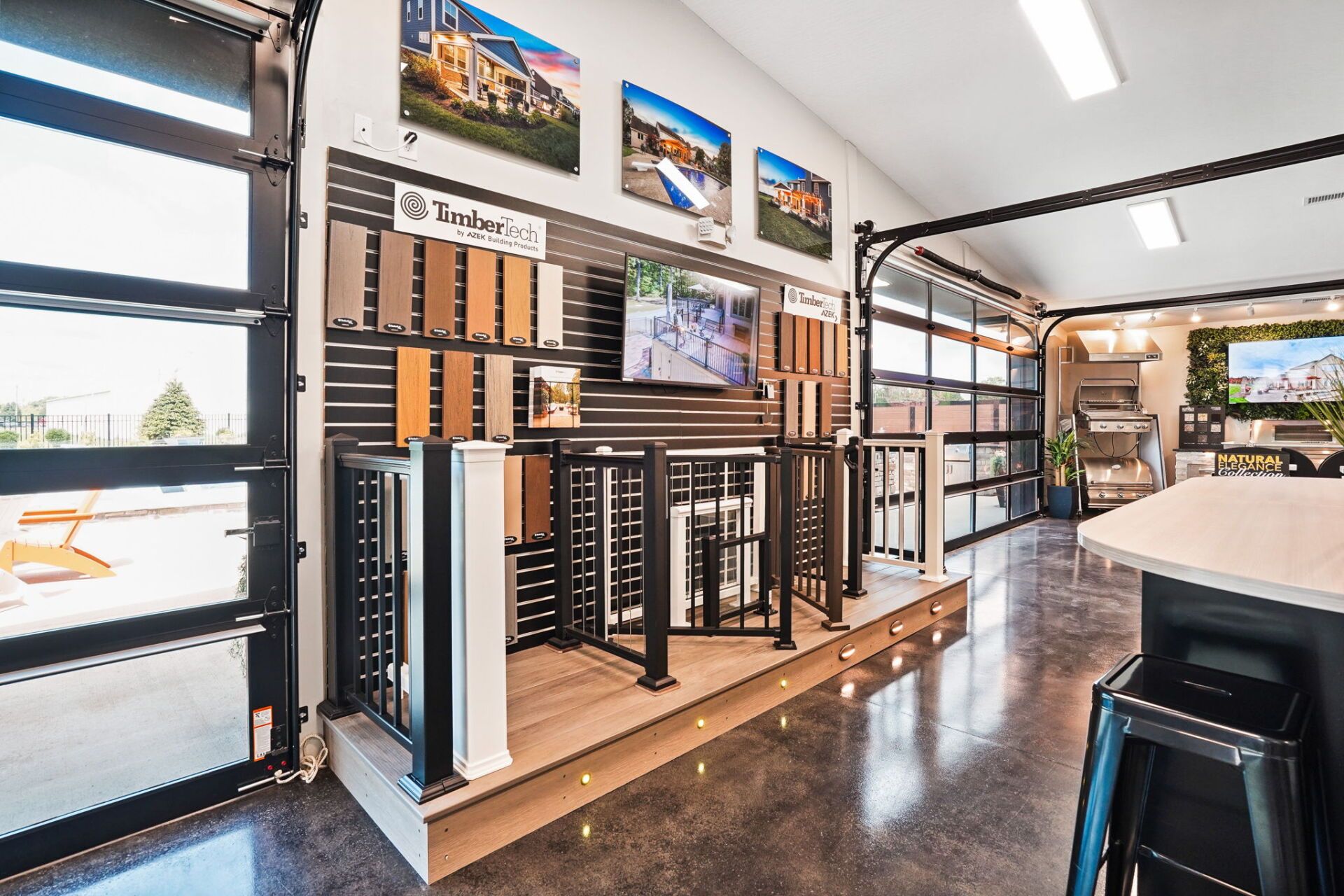 Modern showroom with window blinds, shelving displays, wall art, and polished concrete floor