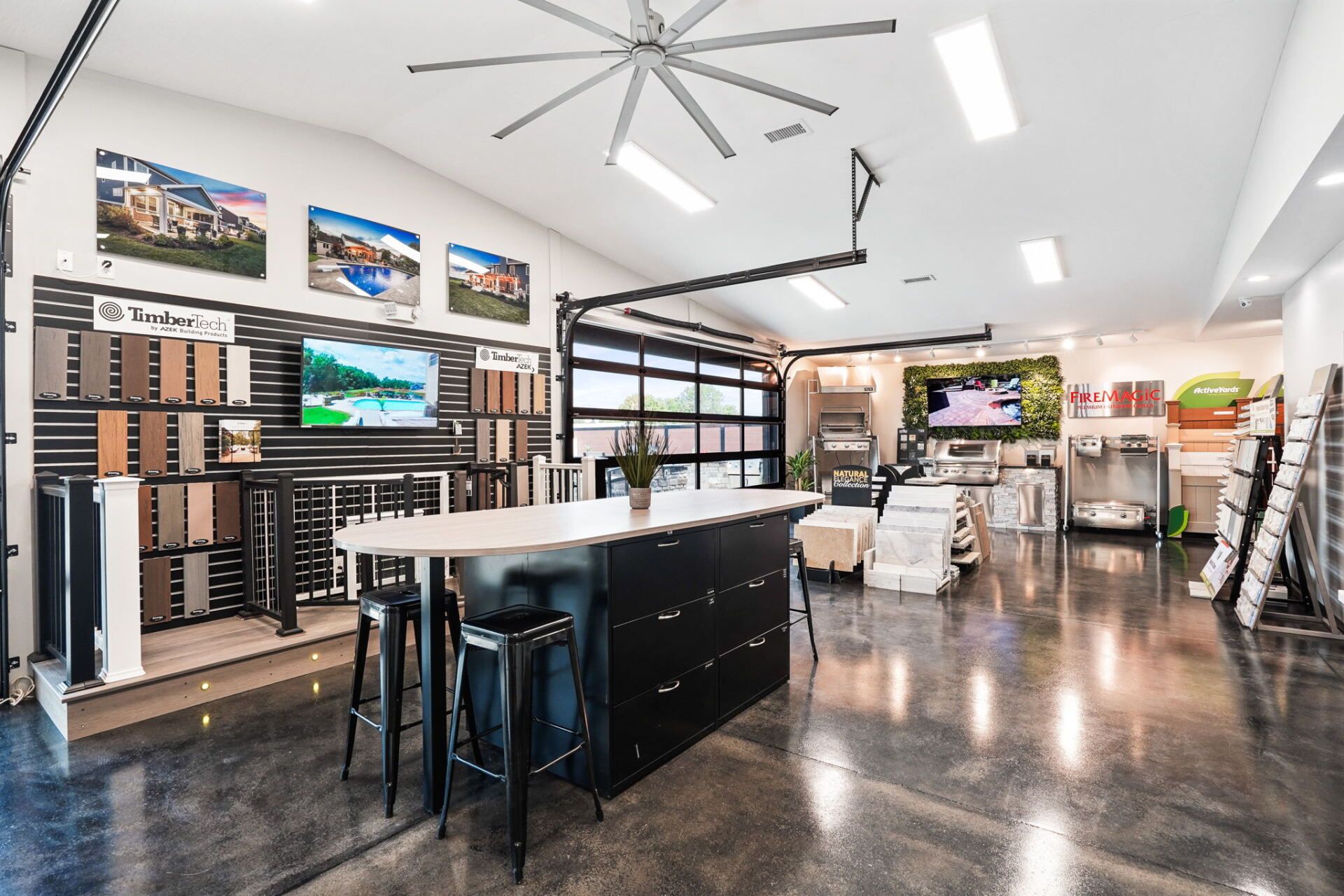 Modern showroom interior with display shelves, workbench, stools, and polished concrete floor