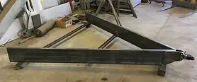 a piece of metal is sitting on the floor in a room .