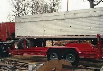 a red trailer with a white trailer attached to it